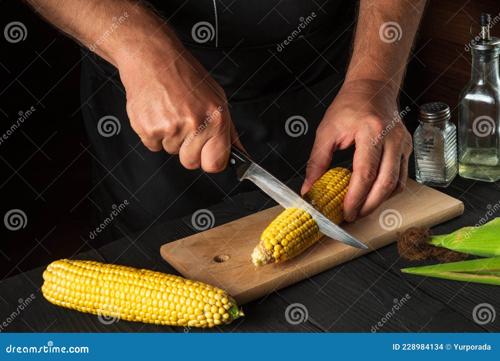 Professional Chef Cuts Fresh Corn with a Knife. Boiled Corn is a Great