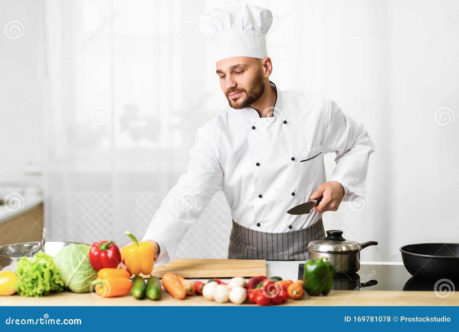 Chef Man Chopping Vegetables on Cutting Board Standing in Kitchen Stock ...