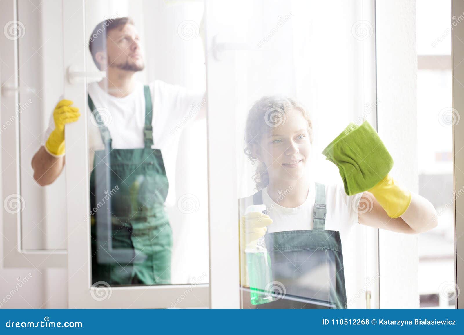 professional cleaners cleaning windows