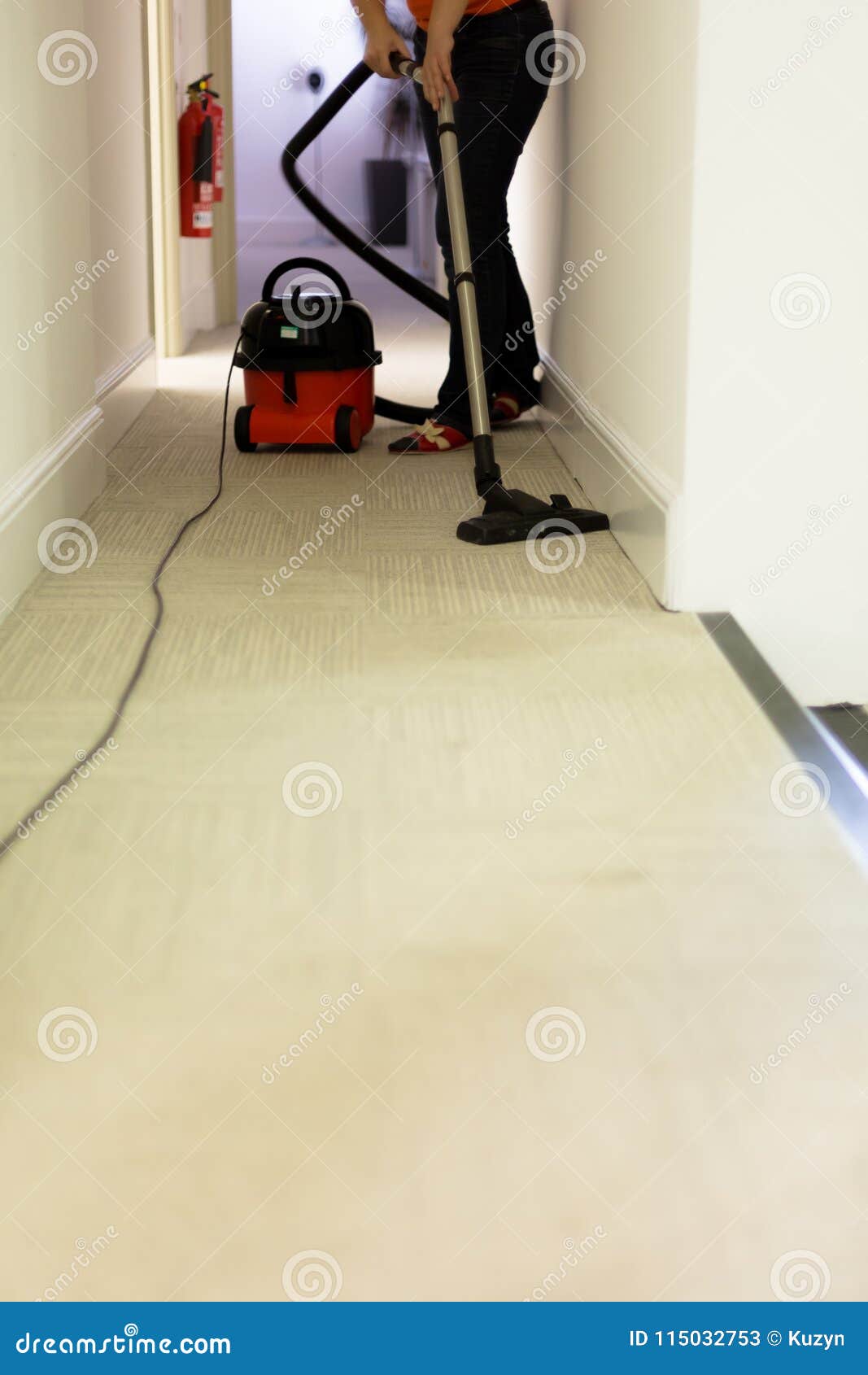 Professional Cleaning Service Woman Hoovering Carpet In Office