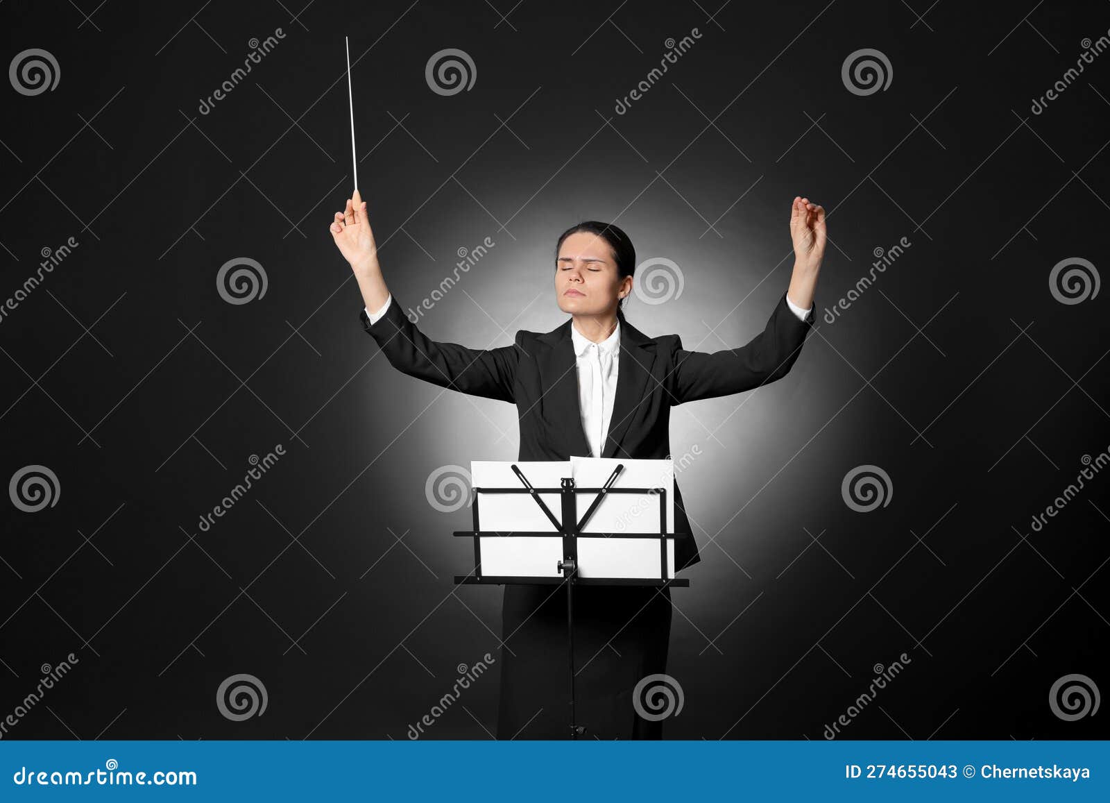 Professional Conductor with Baton and Note Stand on Black Background