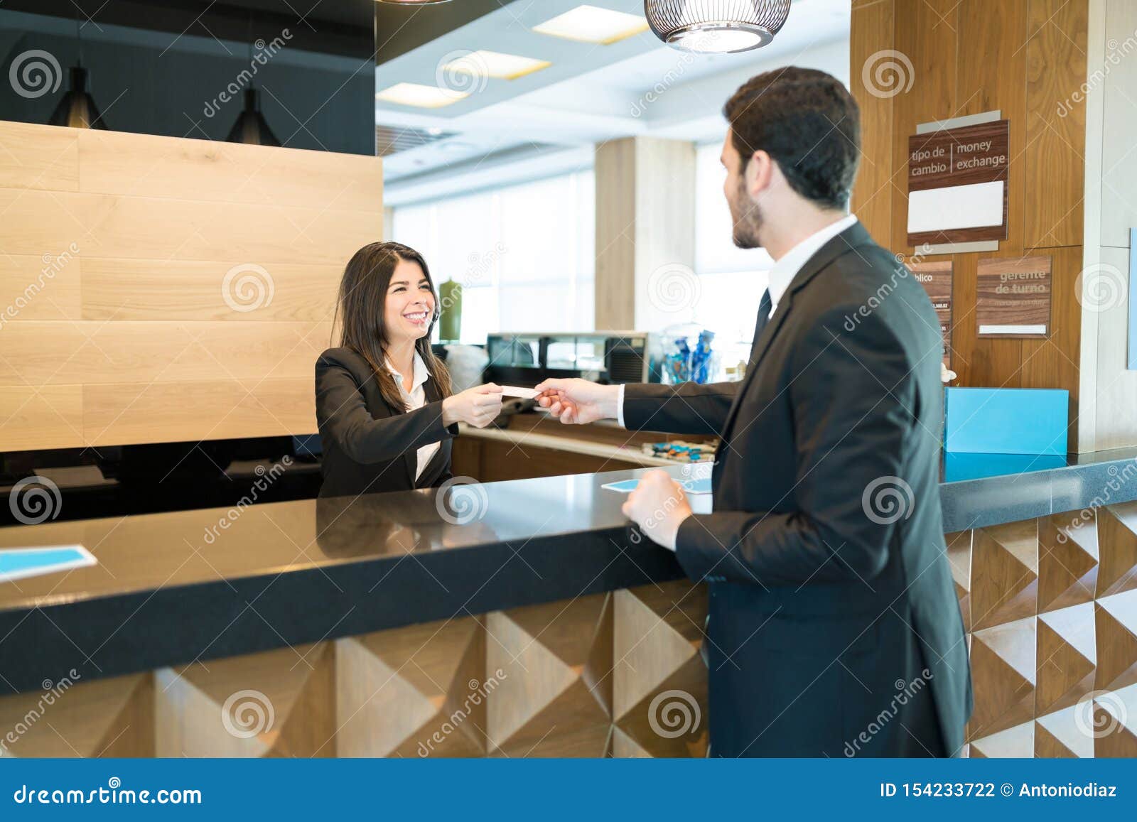 Professional Confirming Reservation At Front Desk Stock Photo