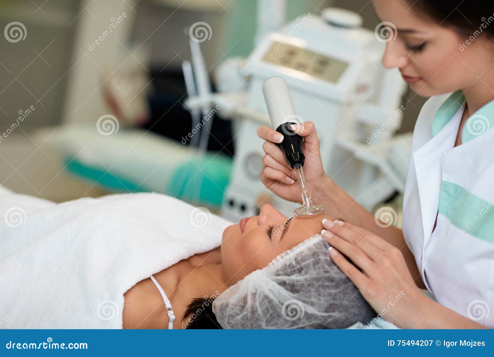 professional cosmetologist undergoing darsonvalization on skin o