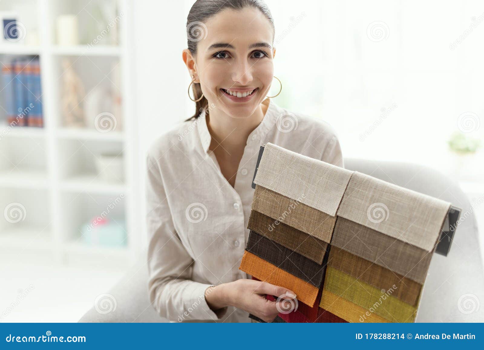 Professional Decorator Choosing The Best Upholstery For The Armchair