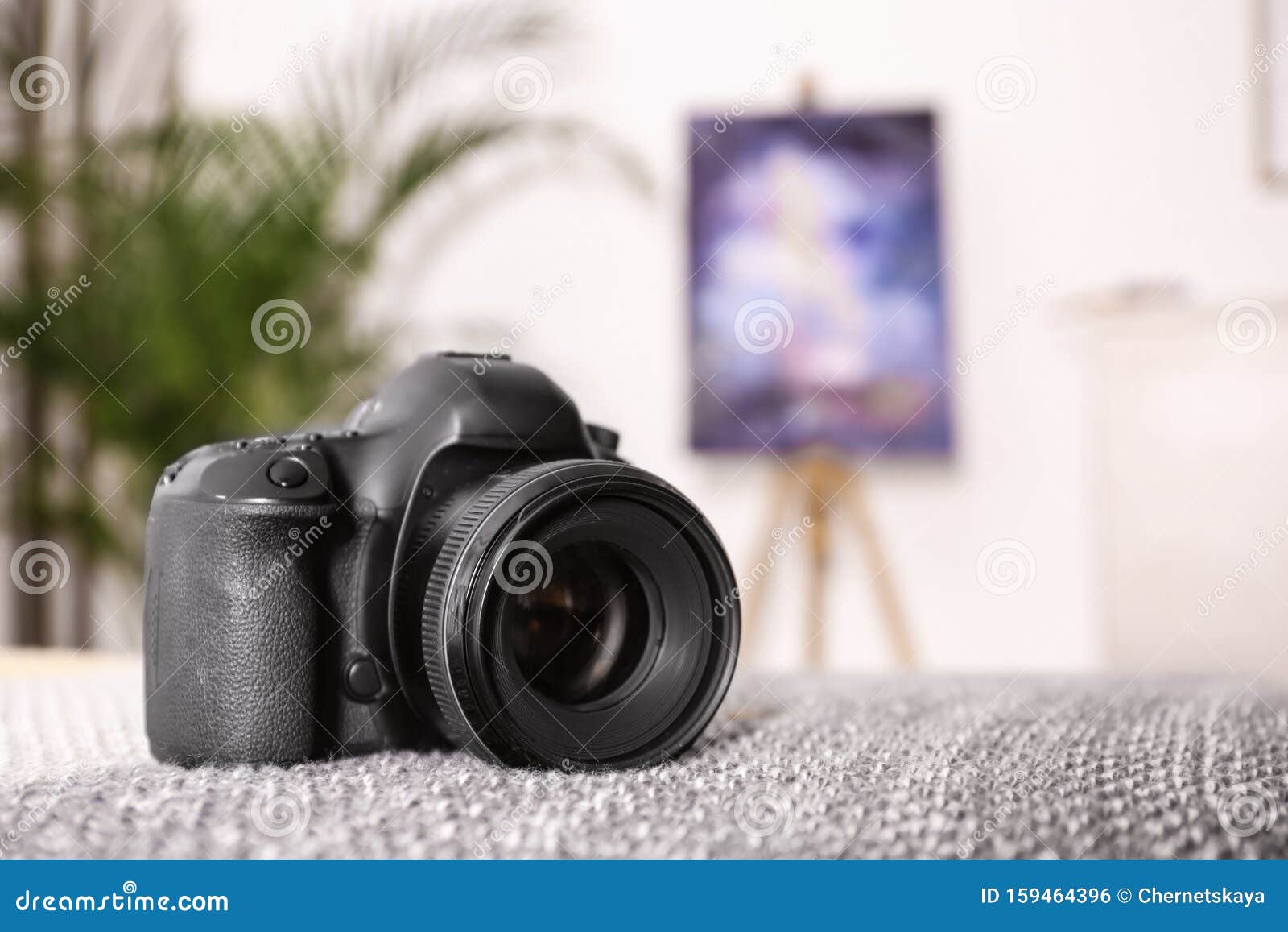 Professional Digital Camera Against Blurred Background Stock Photo