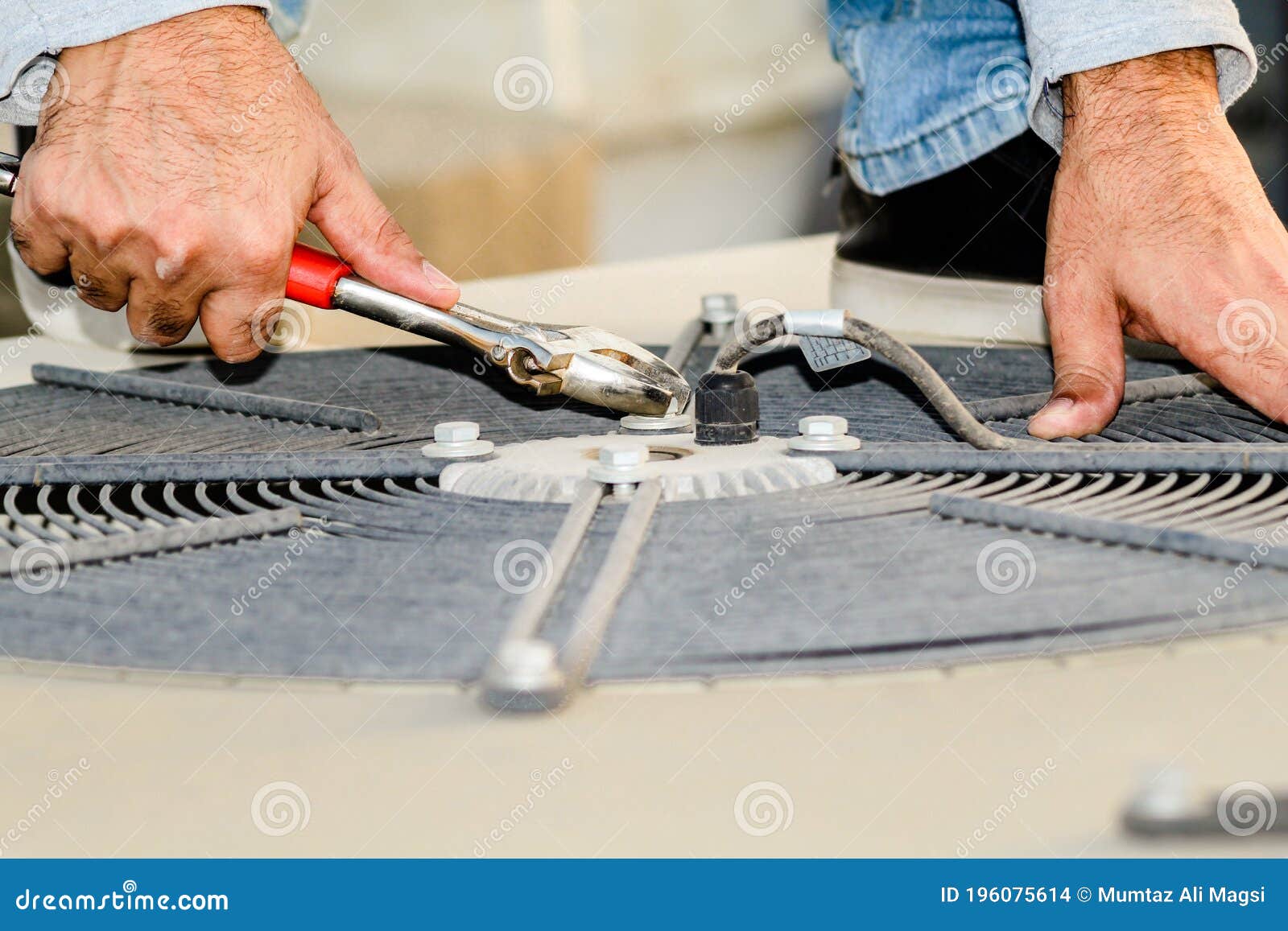 A Professional Electrician Man is Refiling the Freon or Gas into the