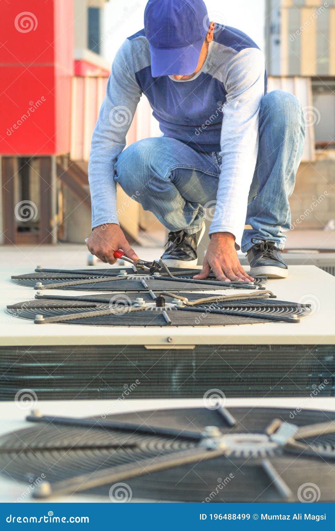 A Professional Electrician Man is Refiling the Freon or Gas into the