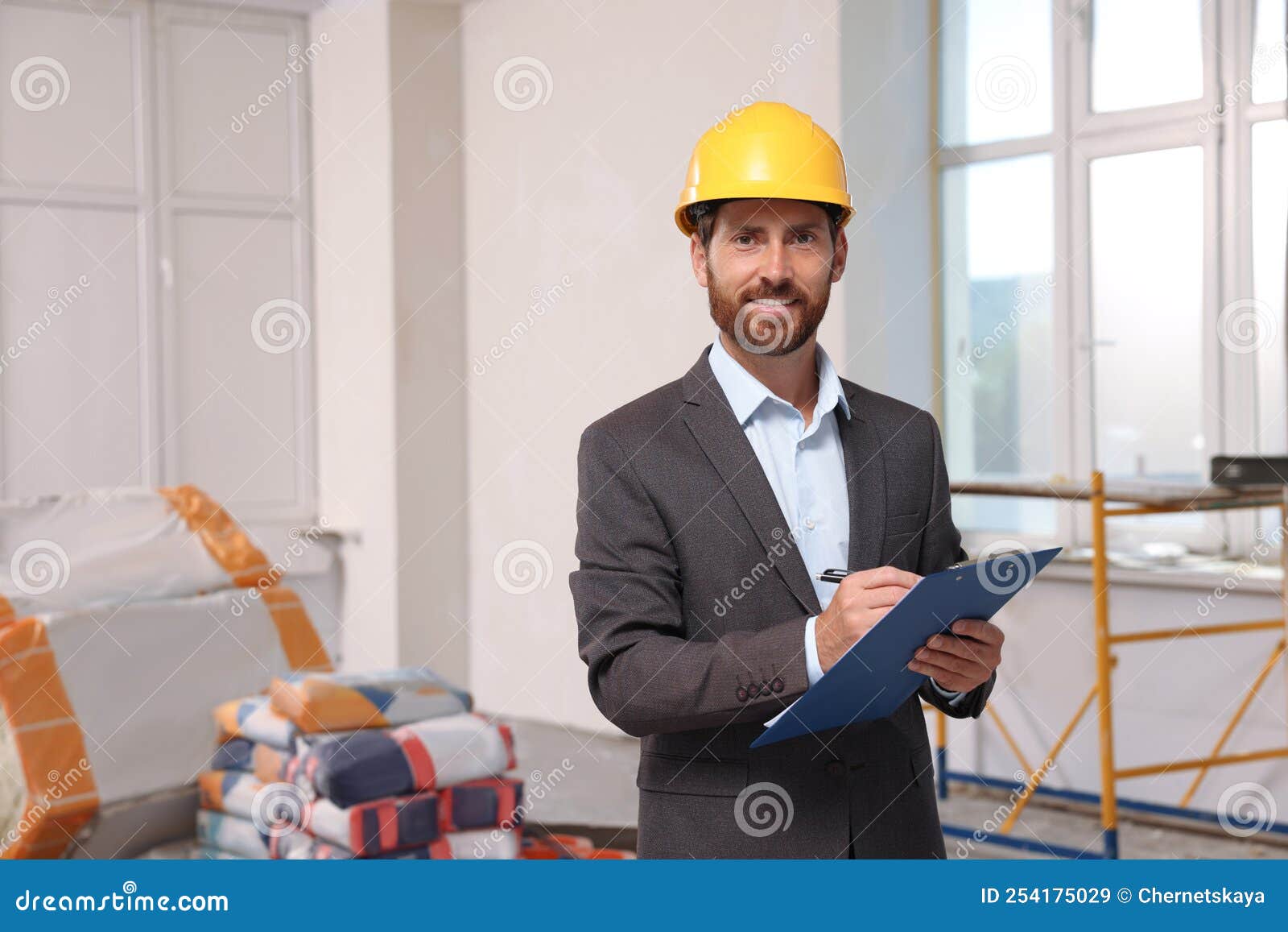 Professional Engineer in Hard Hat with Clipboard Indoors Stock Image