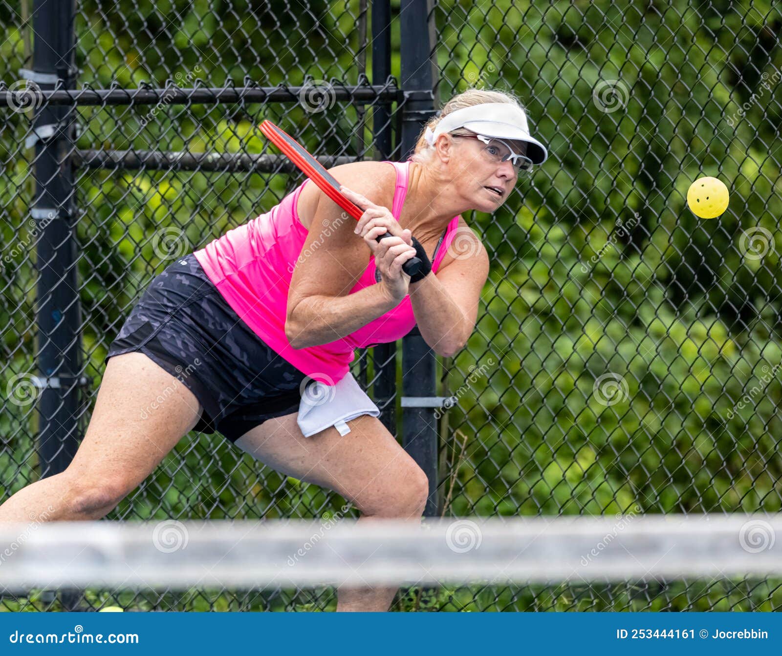 Professional Female Pickelball Player Returns a Two Handed Backhand