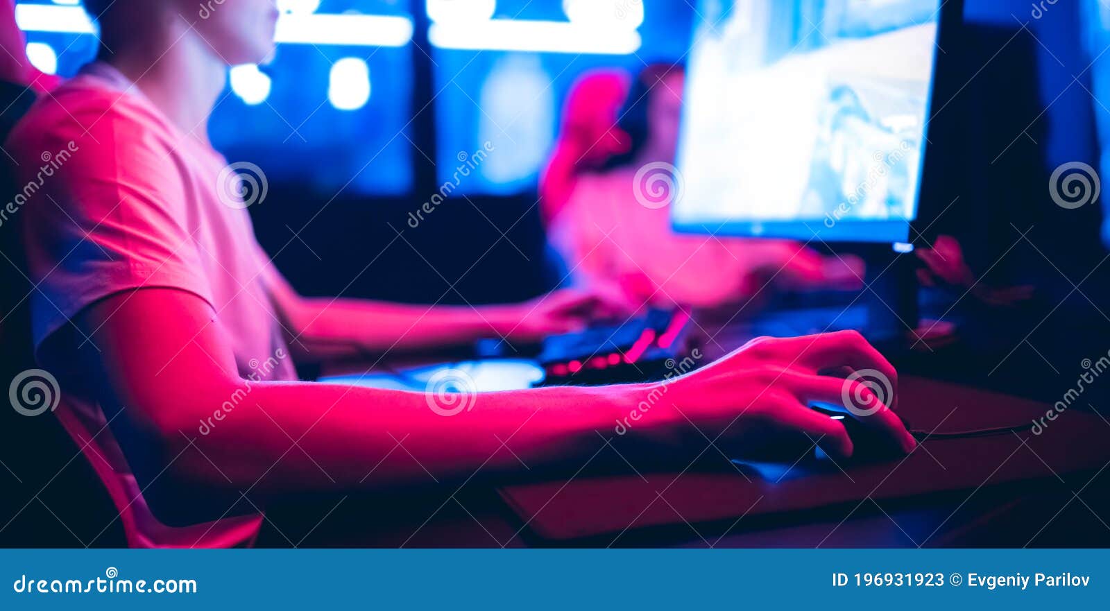 Professional Gamer Playing Online Games Tournaments Pc Computer with Headphones, Blurred Red and Blue Background Stock Image
