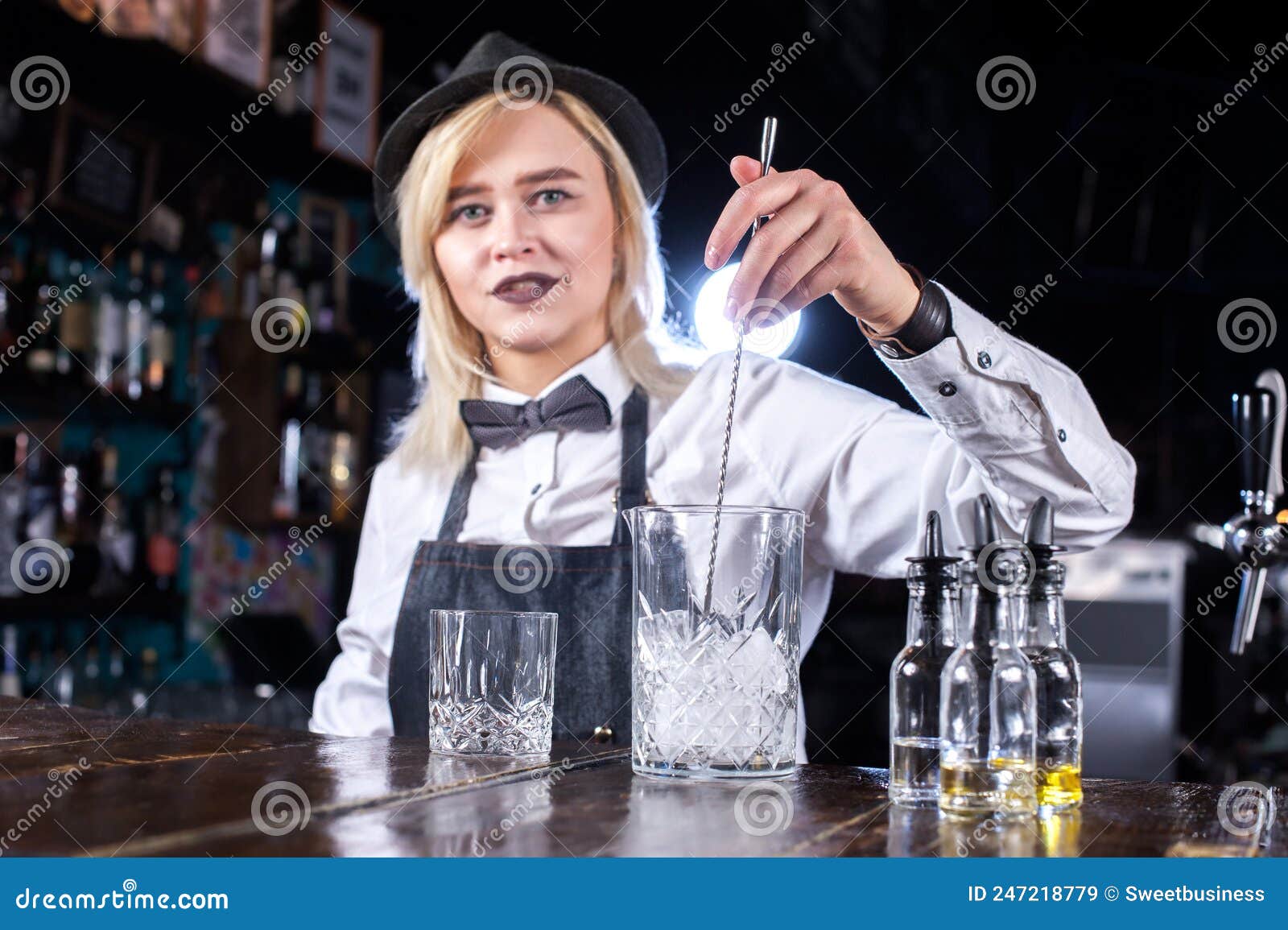 Portrait of Woman Bartending Adds Ingredients To a Cocktail while ...