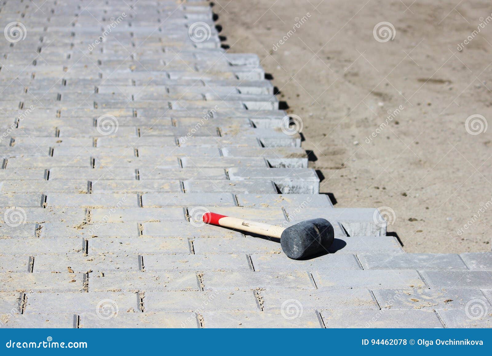 A Professional Hammer for Fitting Paving Slabs To Each Other Stock