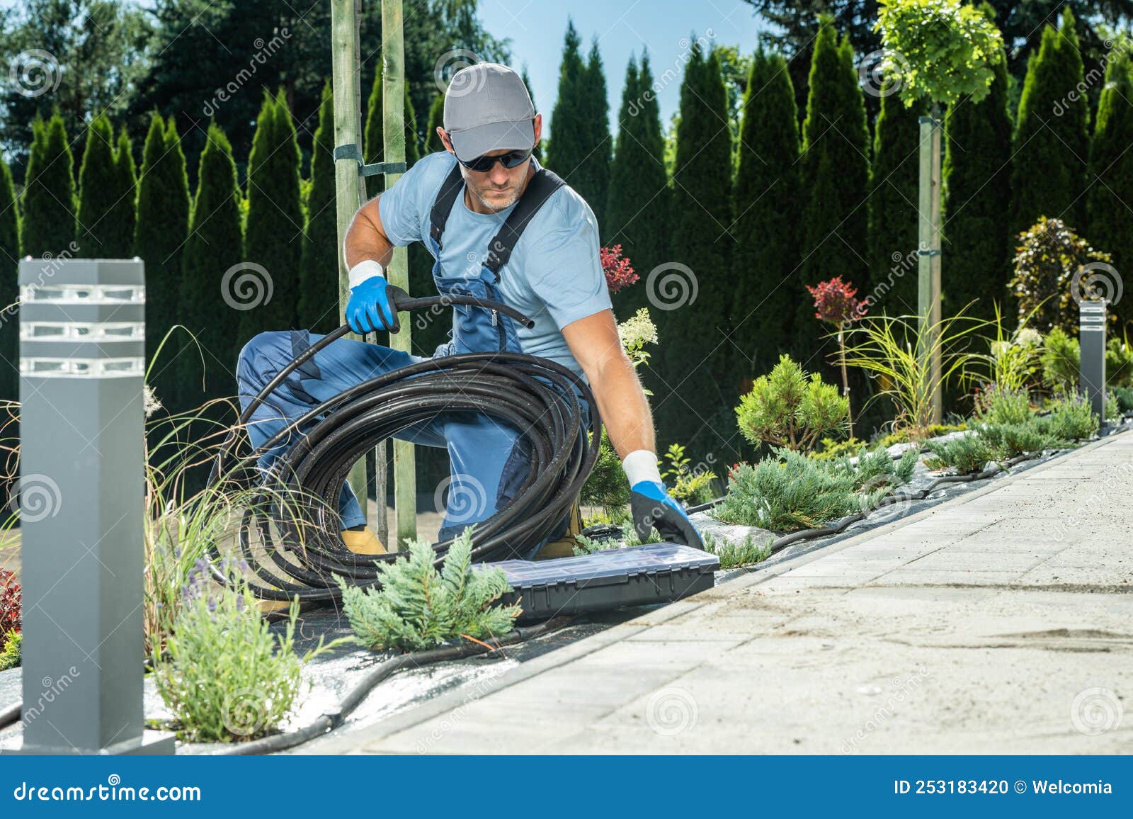 landscaping worker preparing trickle irrigation plastic pipe