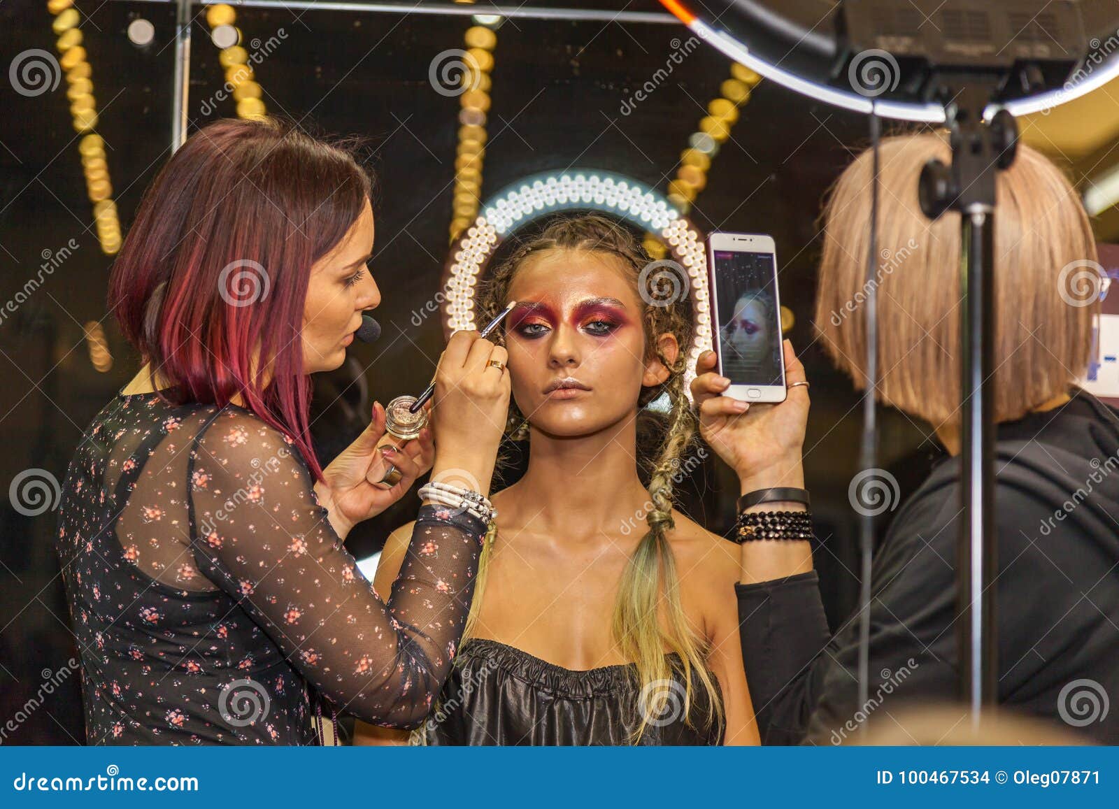 Professional Makeup Artists Work with the Model Editorial Stock Image