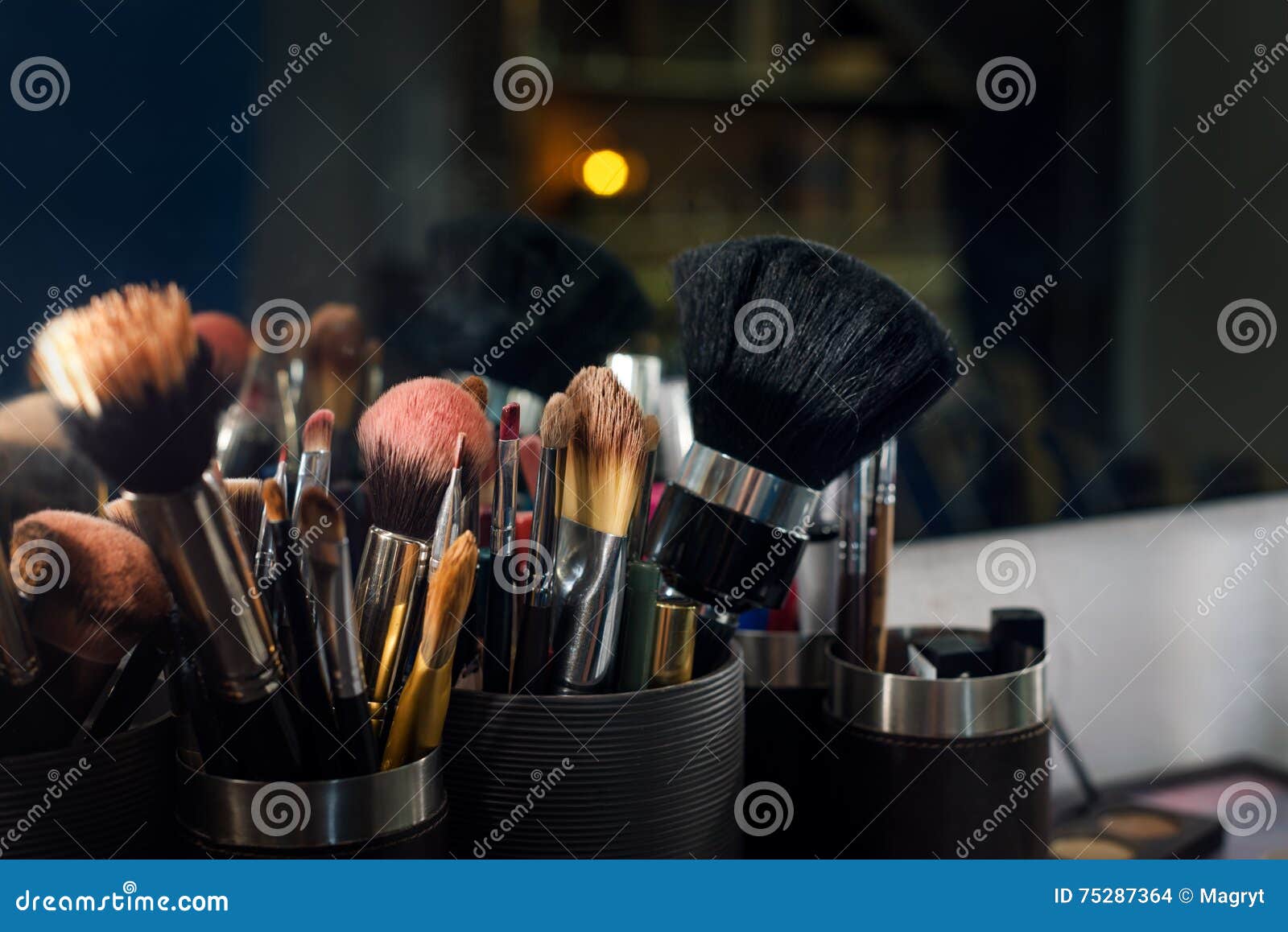 Professional Makeup Brushes Set Closeup Near Salon Mirror. Stock Photo