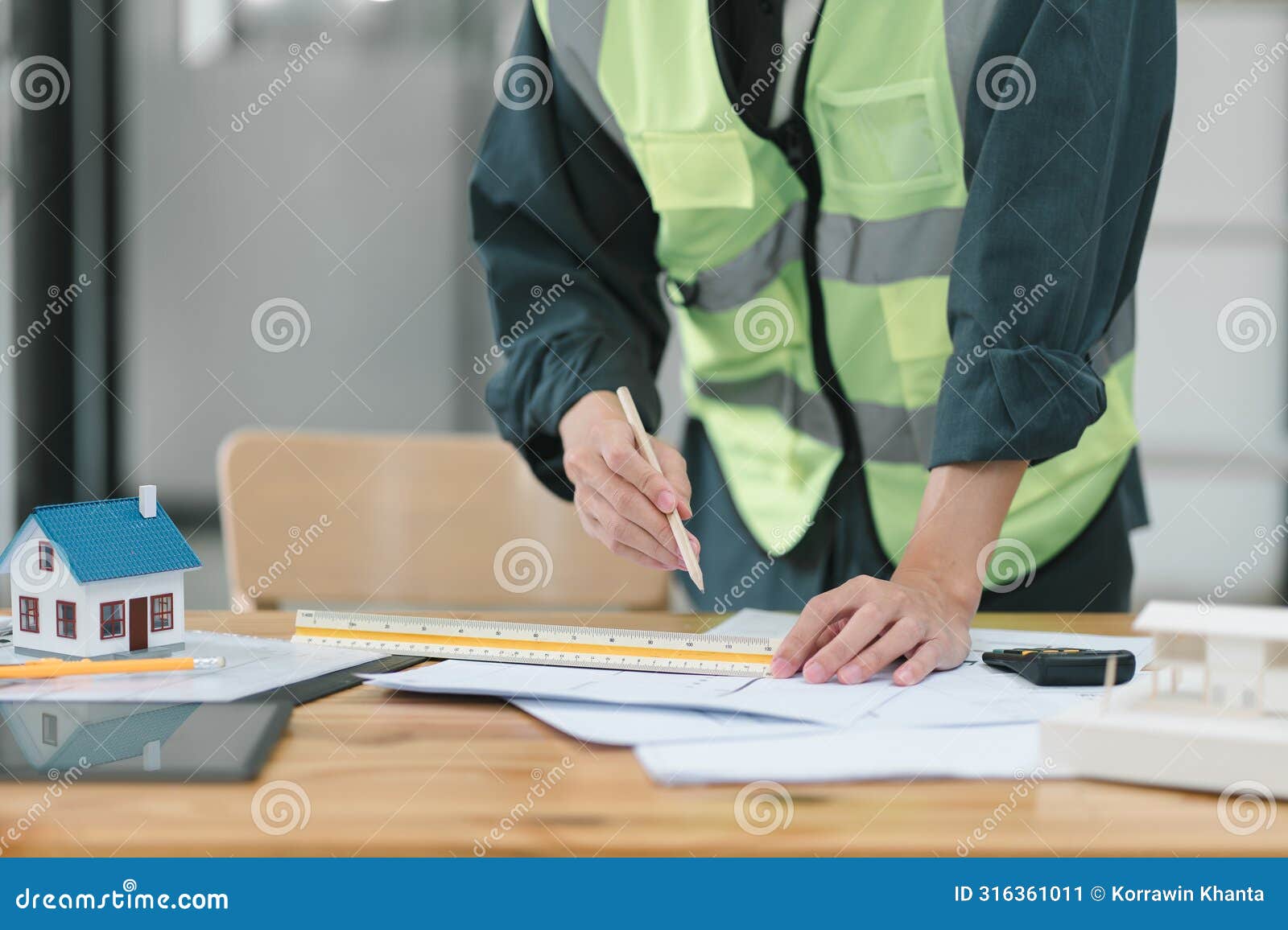 professional male construction engineer reviewing blueprints on worksite.