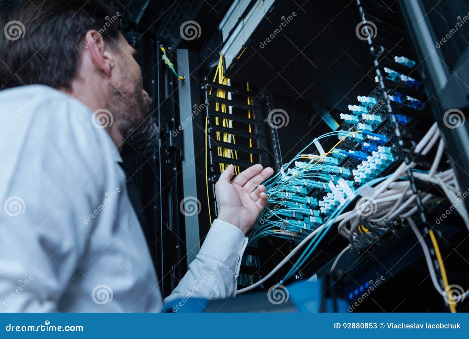 Professional Male Technician Looking at the Cables Stock Image