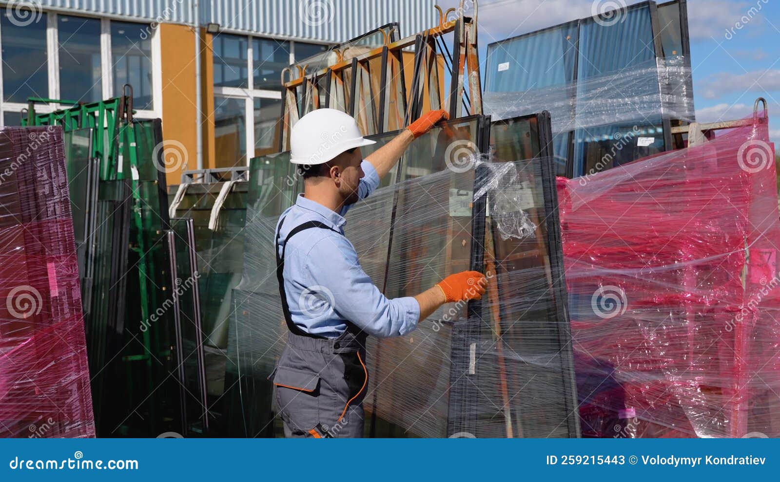 Professional Man Worker in a Window Warehouse Prepares Windows for