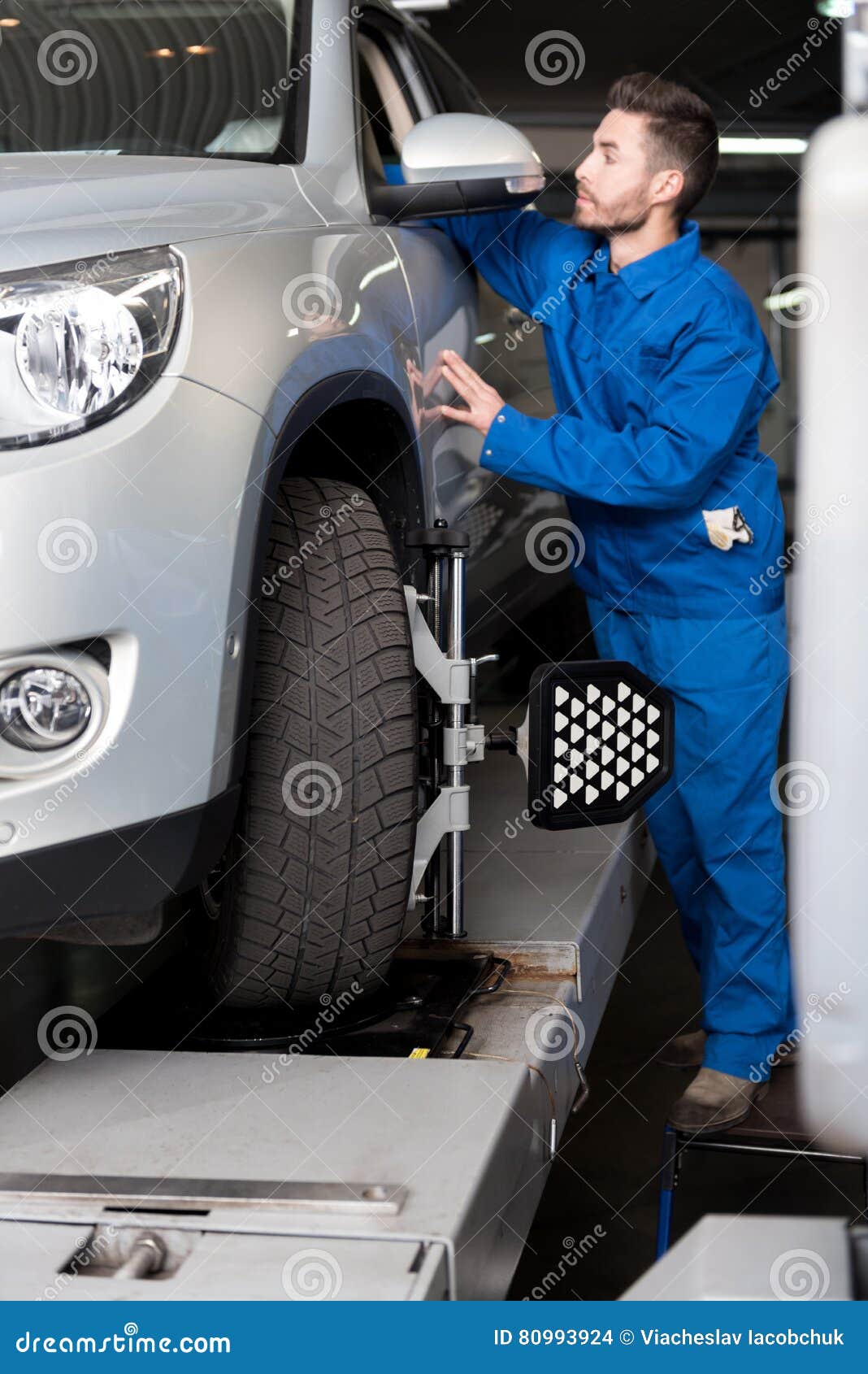 Professional Mechanic Adjusting Automobile Wheel Alignment Stock Photo