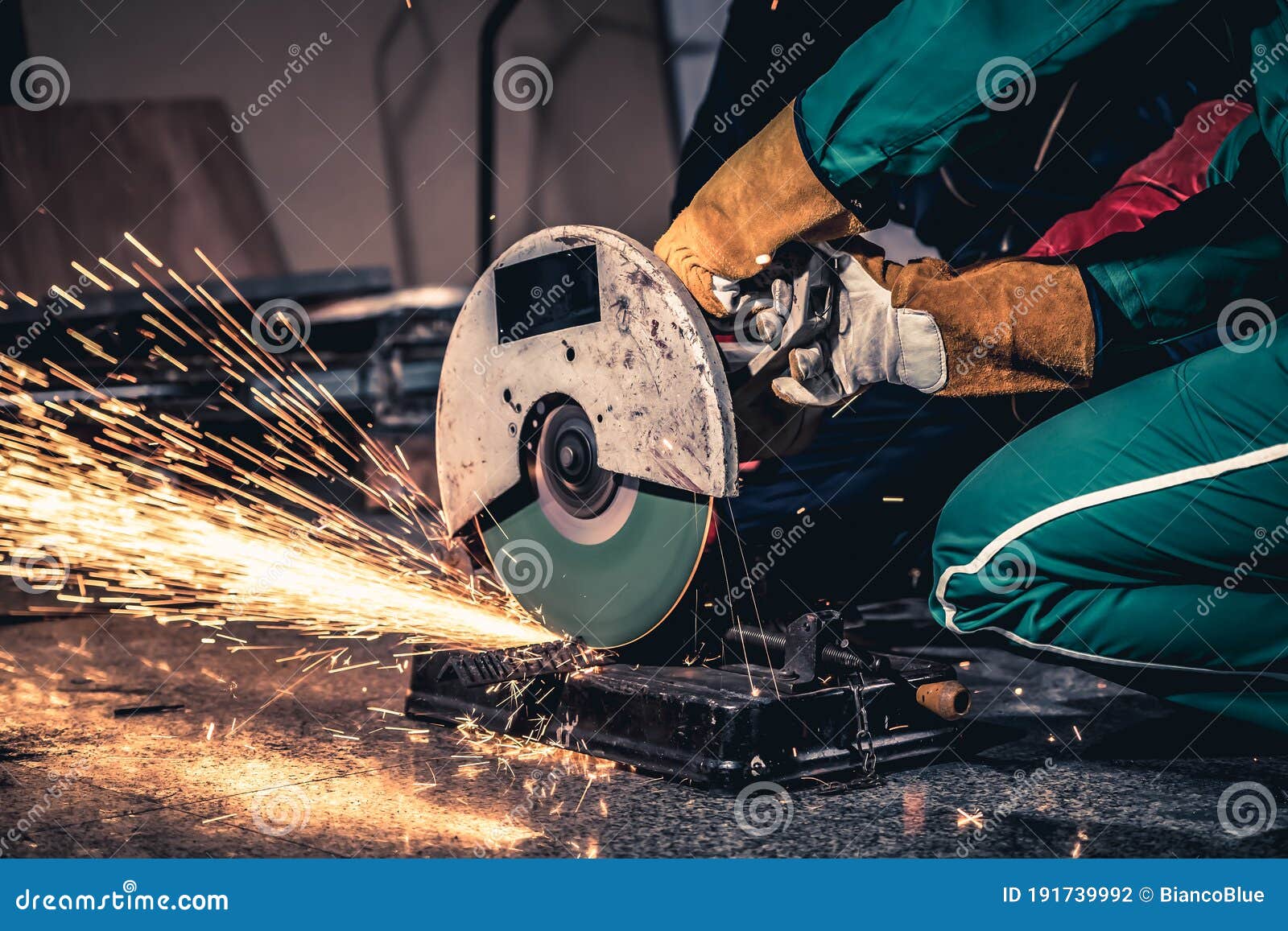 Professional Mechanic Man is Cutting Steel Metal with Rotating Carbon