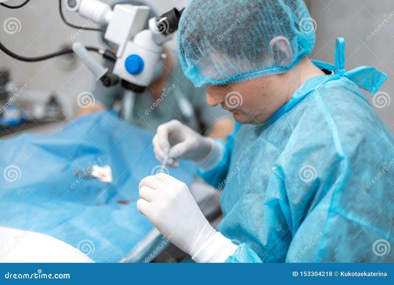 A Professional Ophthalmologist Performs Eye Surgery With A Microscope