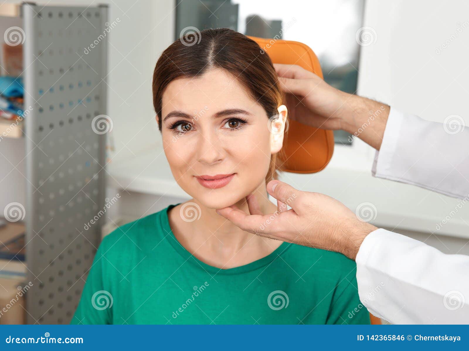 Professional Otolaryngologist Examining Woman In Clinic Stock Photo