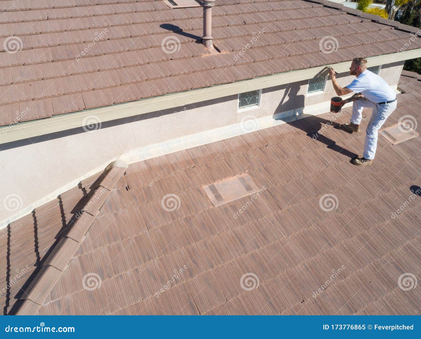 Professional Painter Using a Brush To Paint House Fascia Stock Image