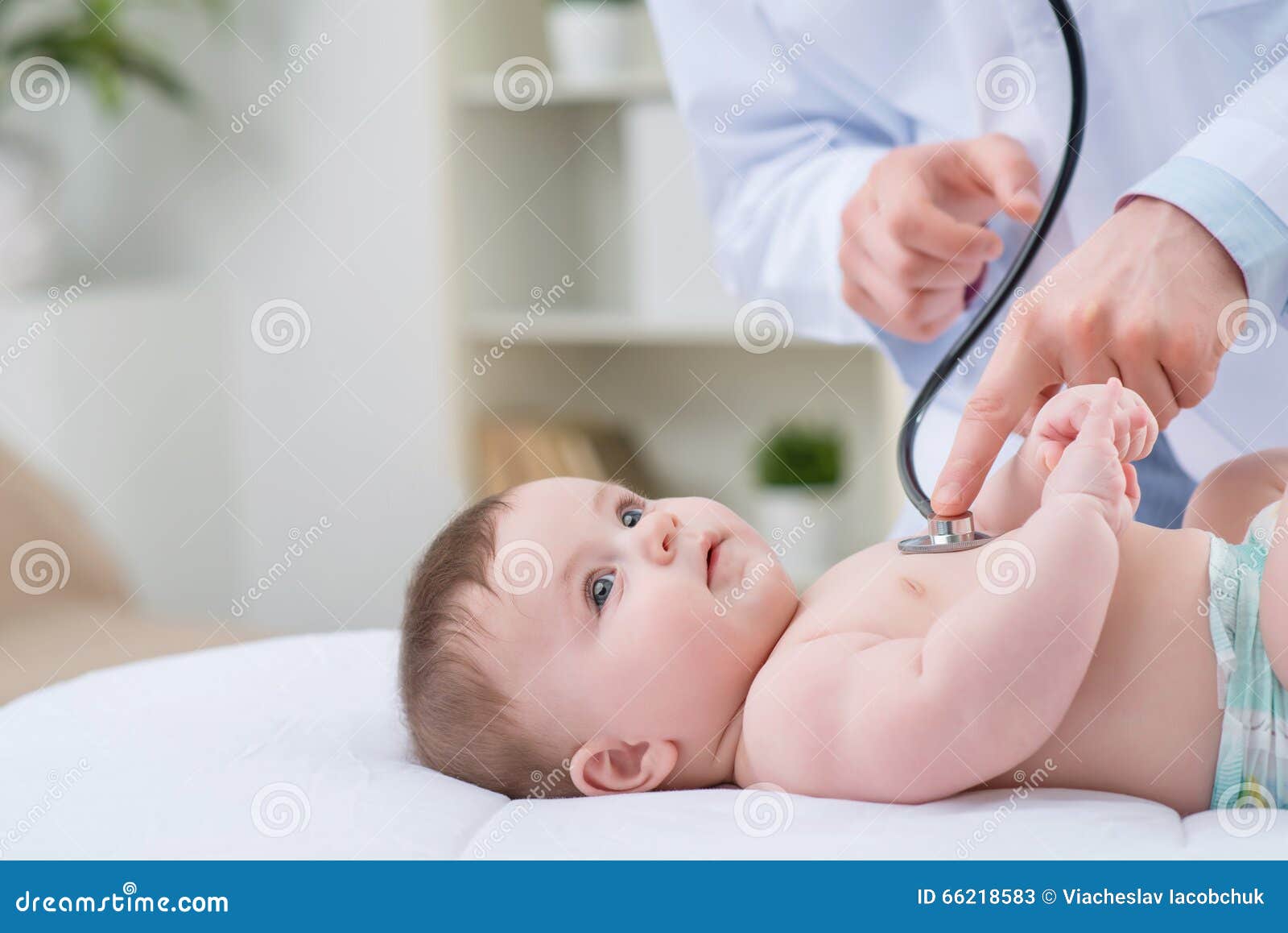 professional pediatrician examining infant