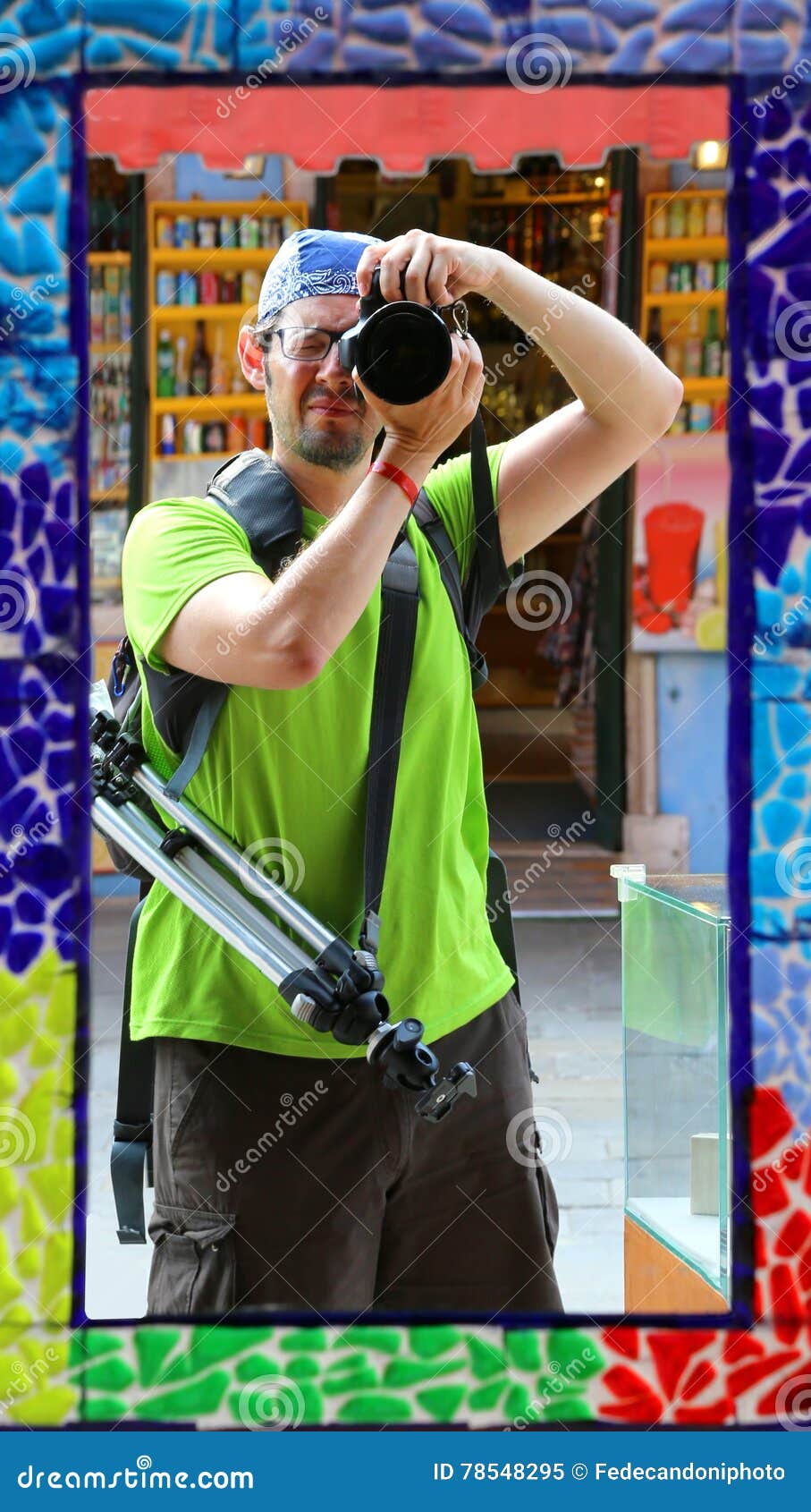 professional photographer with a tripod makes a selfie