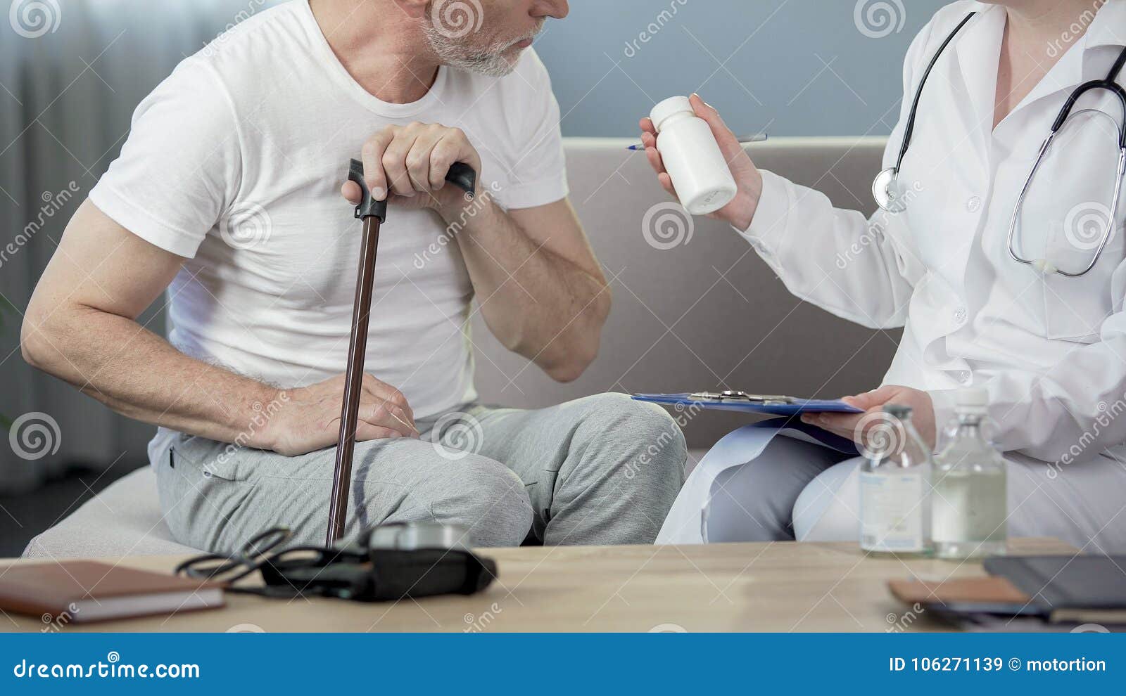 professional physician prescribing medicine to senior man sitting on couch