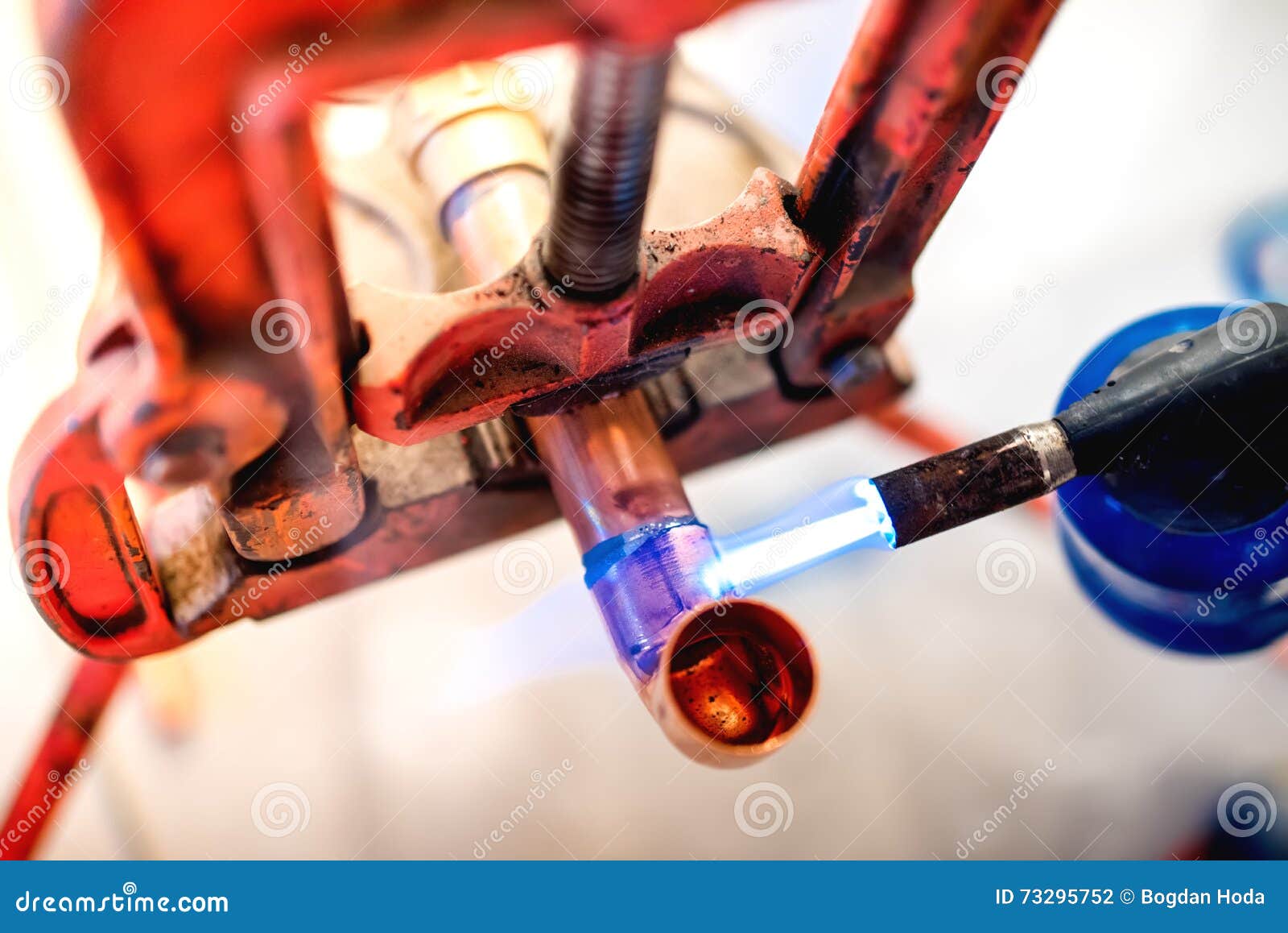 Professional Plumber Welding and Soldering Copper Pipes Stock Photo