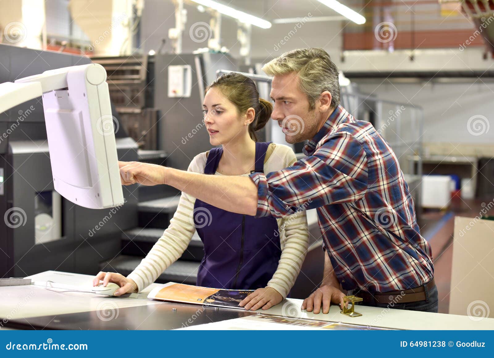 Professional Printer Working With Apprentice Stock Photo 