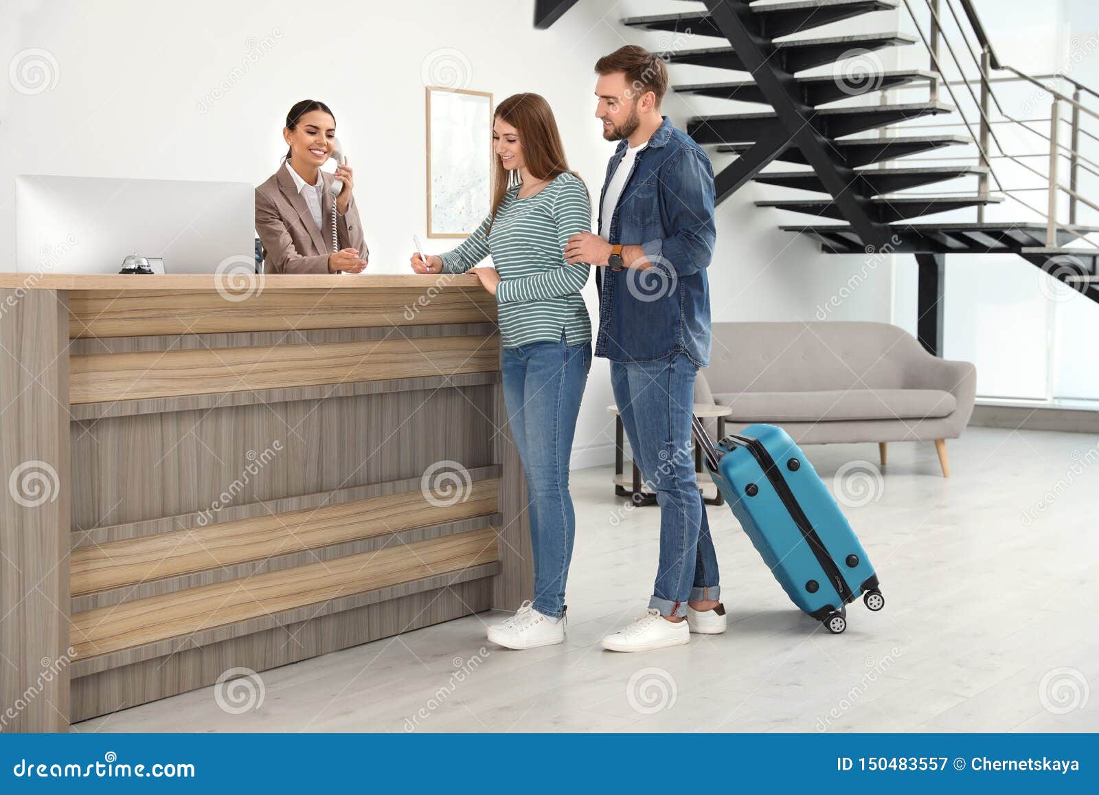 Professional Receptionist Working with Clients at Desk Stock Image