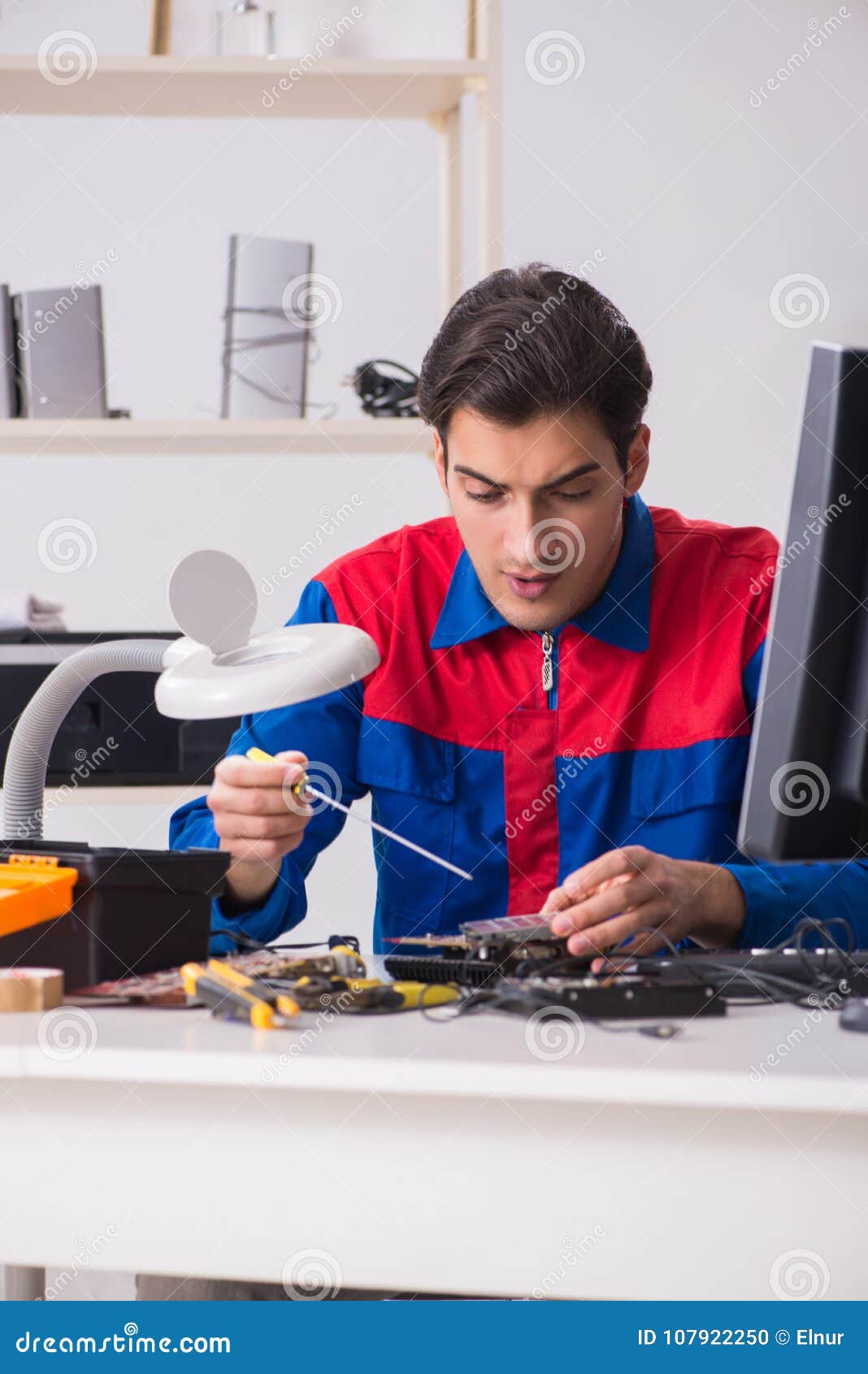The Professional Repairman Repairing Computer in Stock Photo