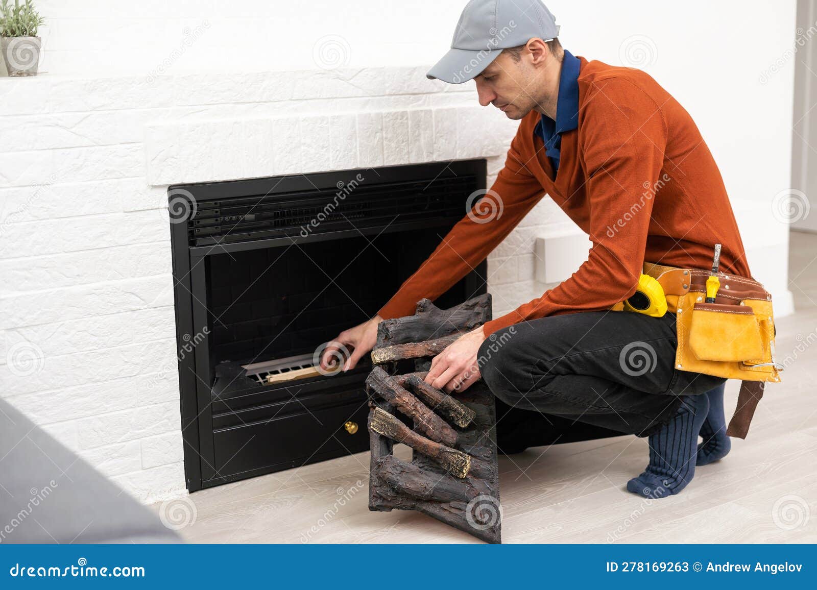 Professional Technician Installing Electric Fireplace in Room. Stock