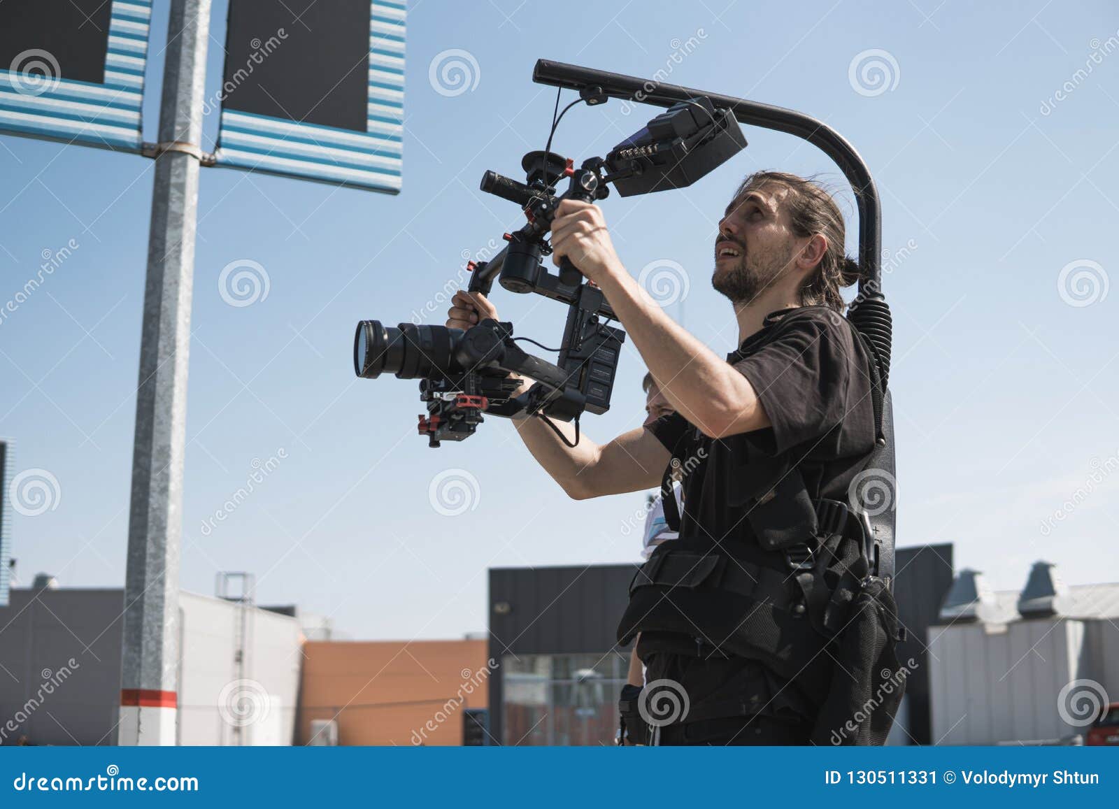 Professional Videographer Holding Camera on 3axis Gimbal Which Mounted on Easy Rig