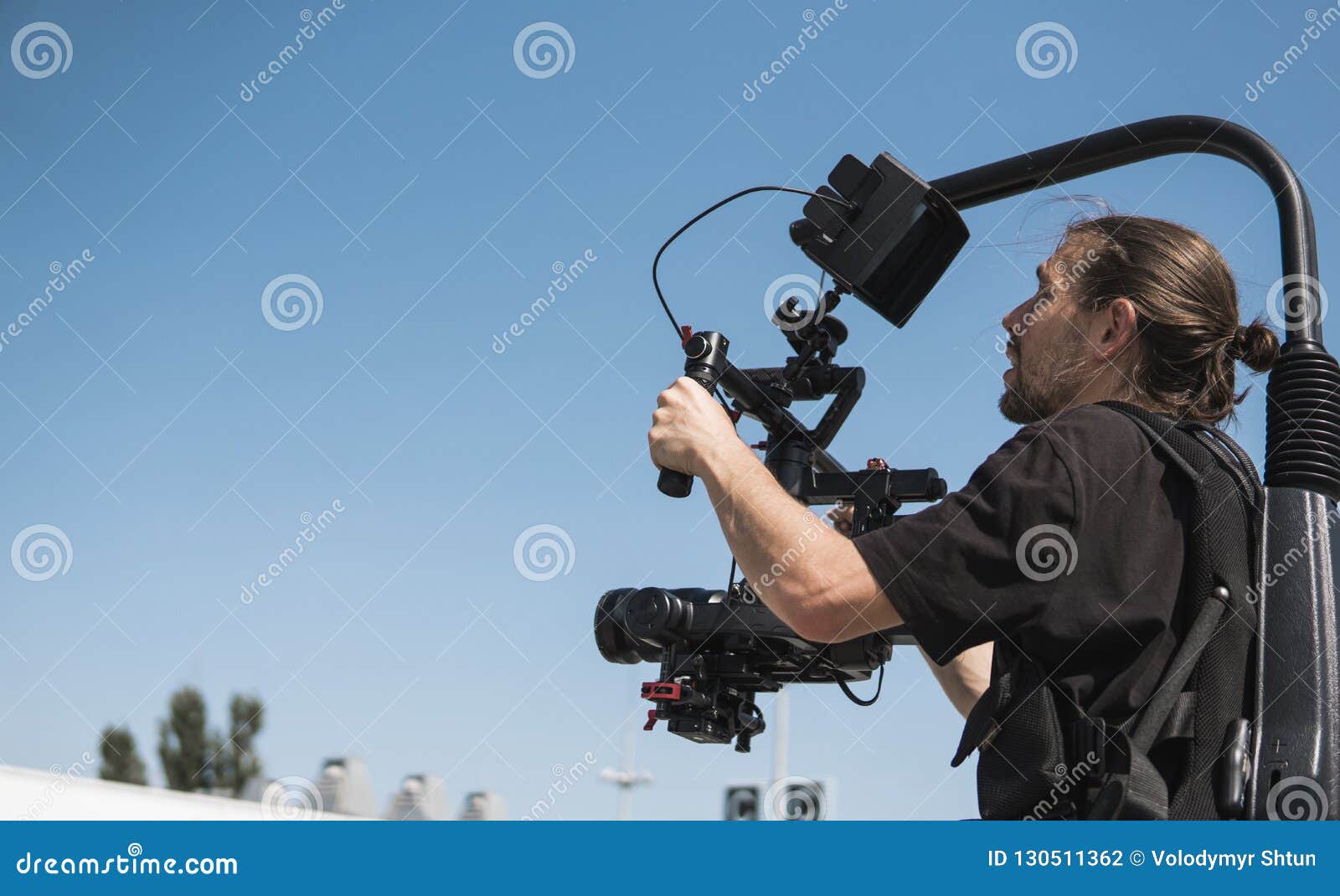 Professional Videographer Holding Camera on 3axis Gimbal Which Mounted on Easy Rig