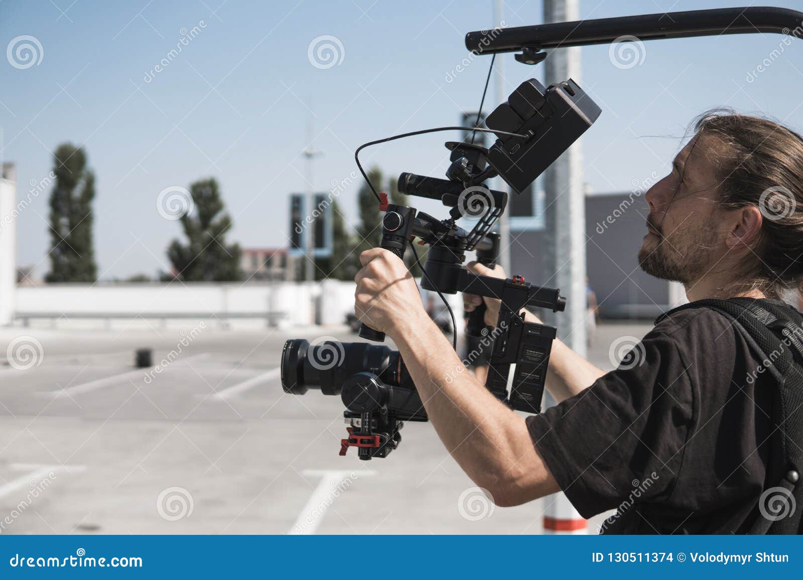 Professional Videographer Holding Camera on 3axis Gimbal Which Mounted on Easy Rig