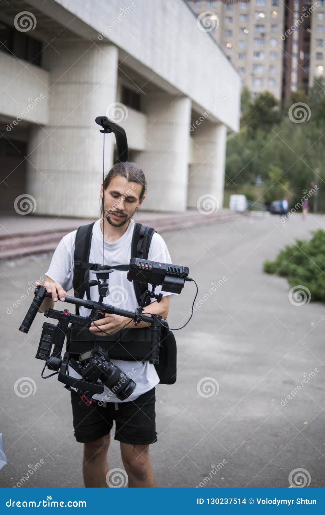 Professional Videographer Holding Camera on 3axis Gimbal Which Mounted on Easy Rig