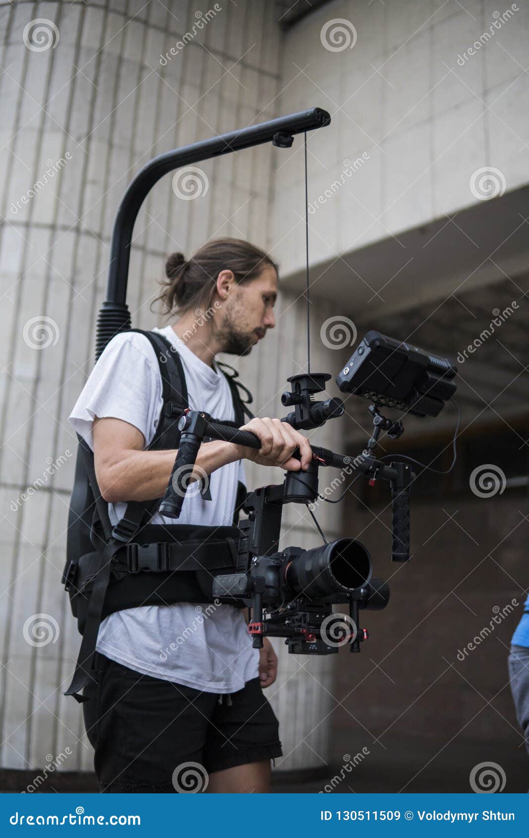 Professional Videographer Holding Camera on 3axis Gimbal Which Mounted on Easy Rig