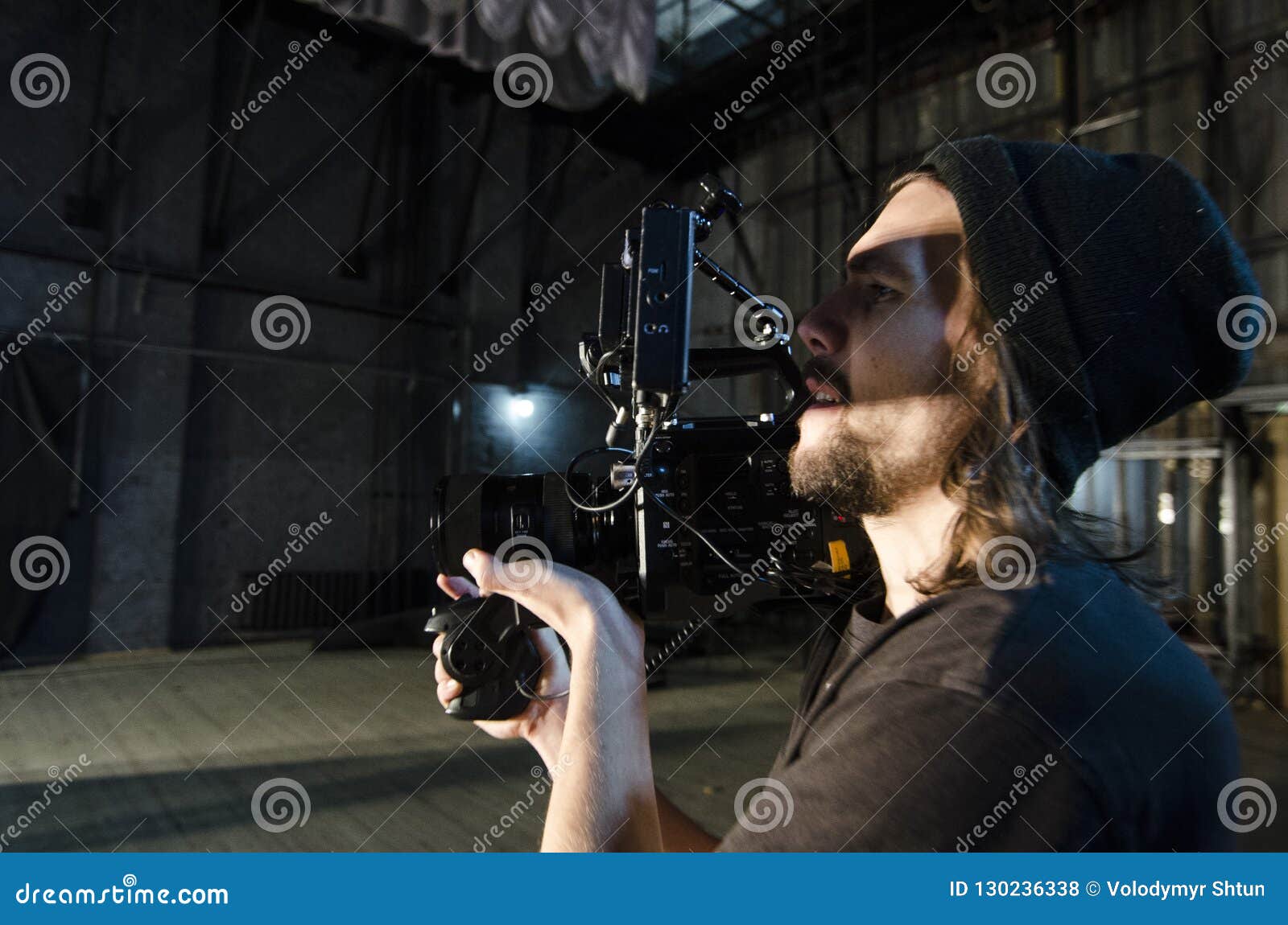 Professional Videographer Using Cinema Digital Video Camera for Filming