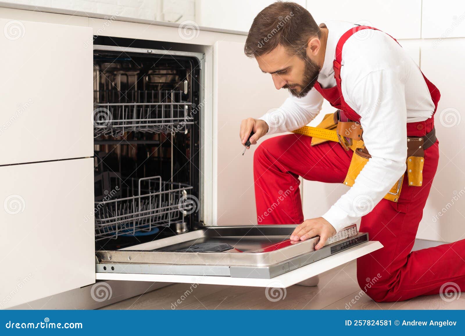 Professional Worker Estimating Cost for Broken Dishwasher Stock Image