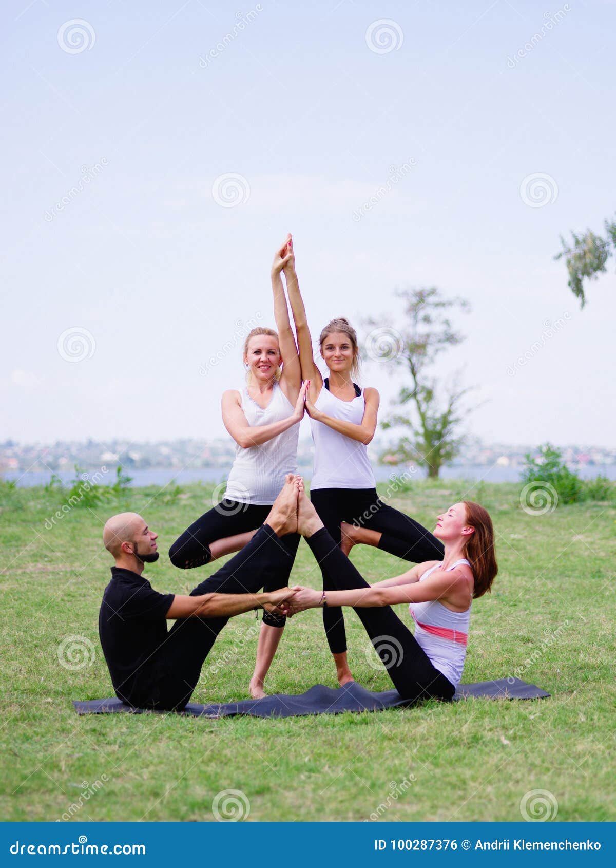 A Group of Four Holds Yoga Classes in the Park. Healthy Lifestyle