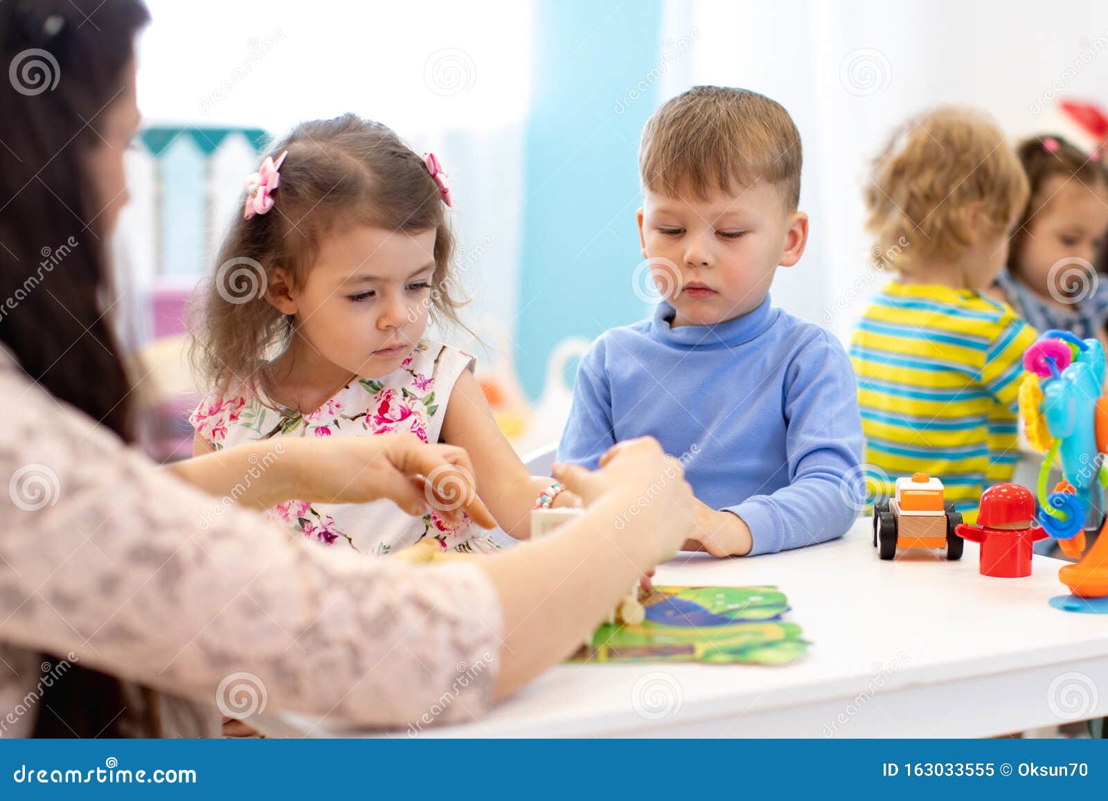 crianças brincando com tijolos e jogos educativos na sala do jardim de  infância. as crianças brincam