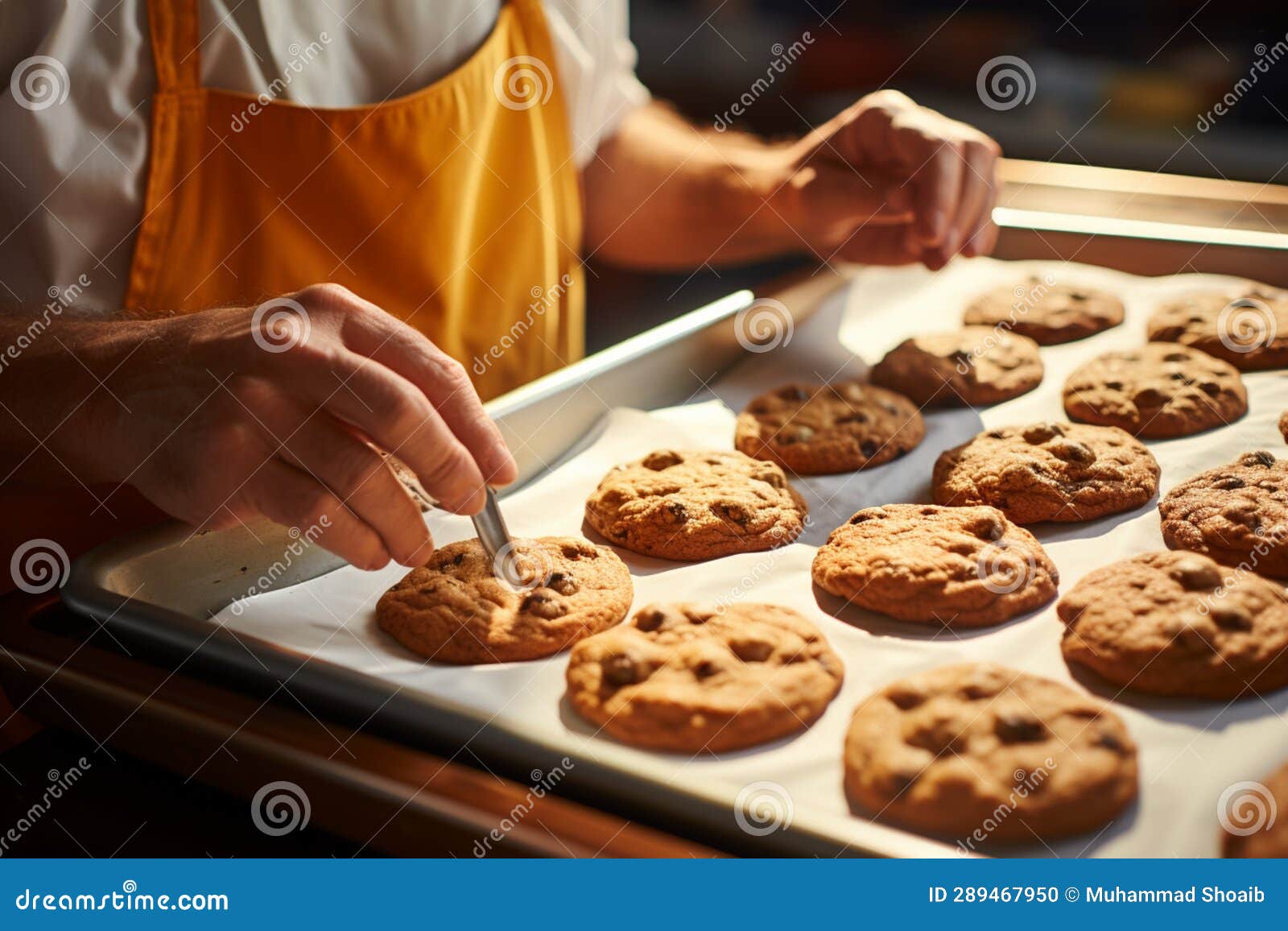a proficient baker skillfully conveys a tray of warm, mouthwatering cookies