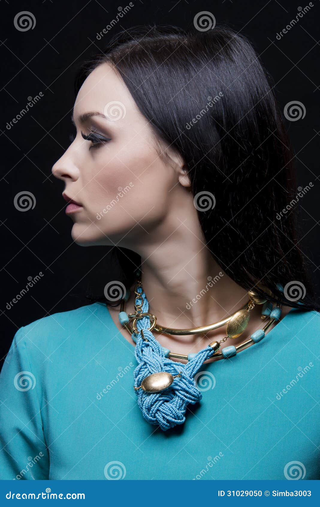 profile of beautiful fashionable woman wearing cyan clothes and jewellery