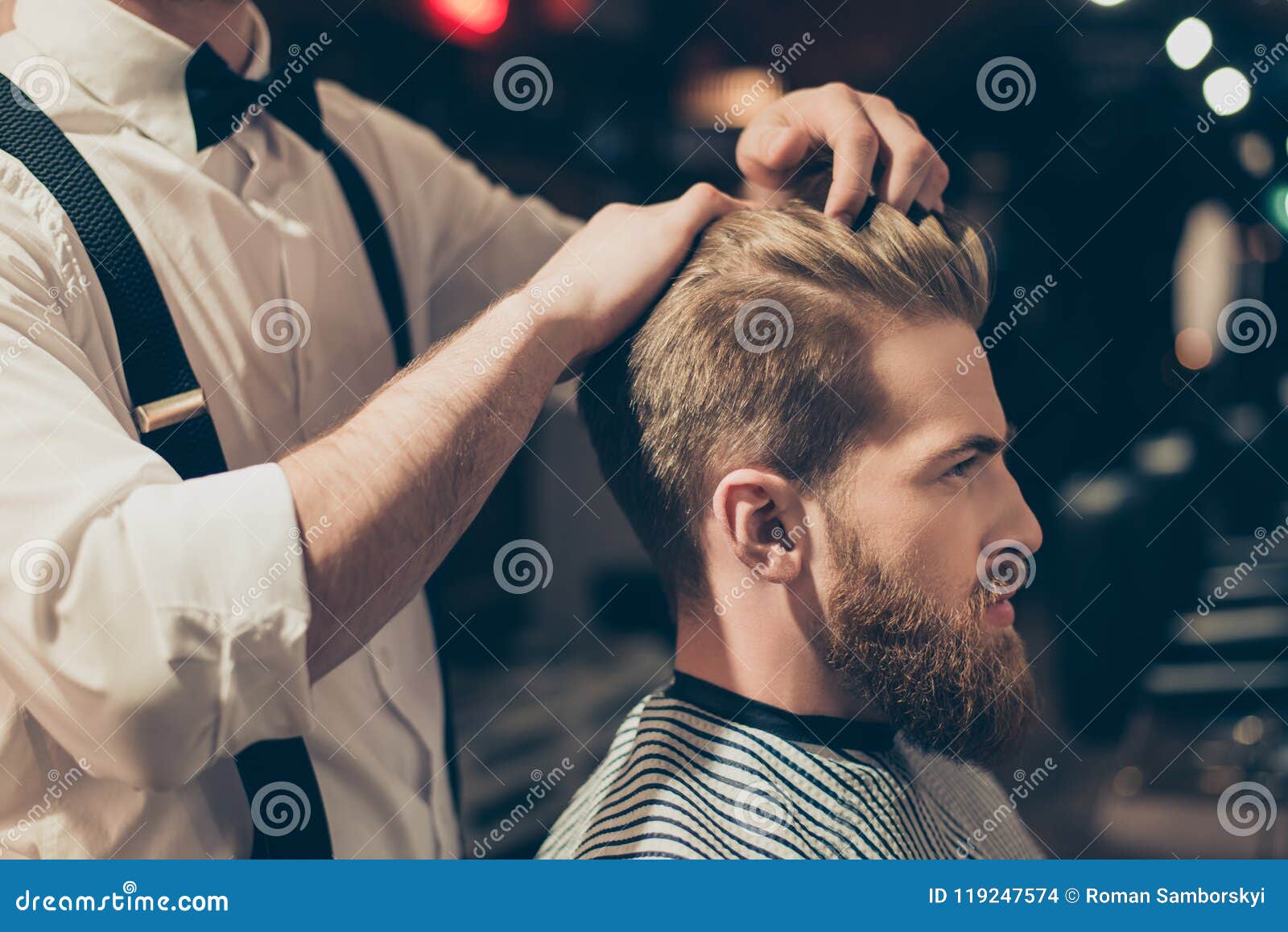 Profile side close up view portrait of handsome virile macho man having his hair cut in barbershop. Fashion hair care concept. Beauty concept.