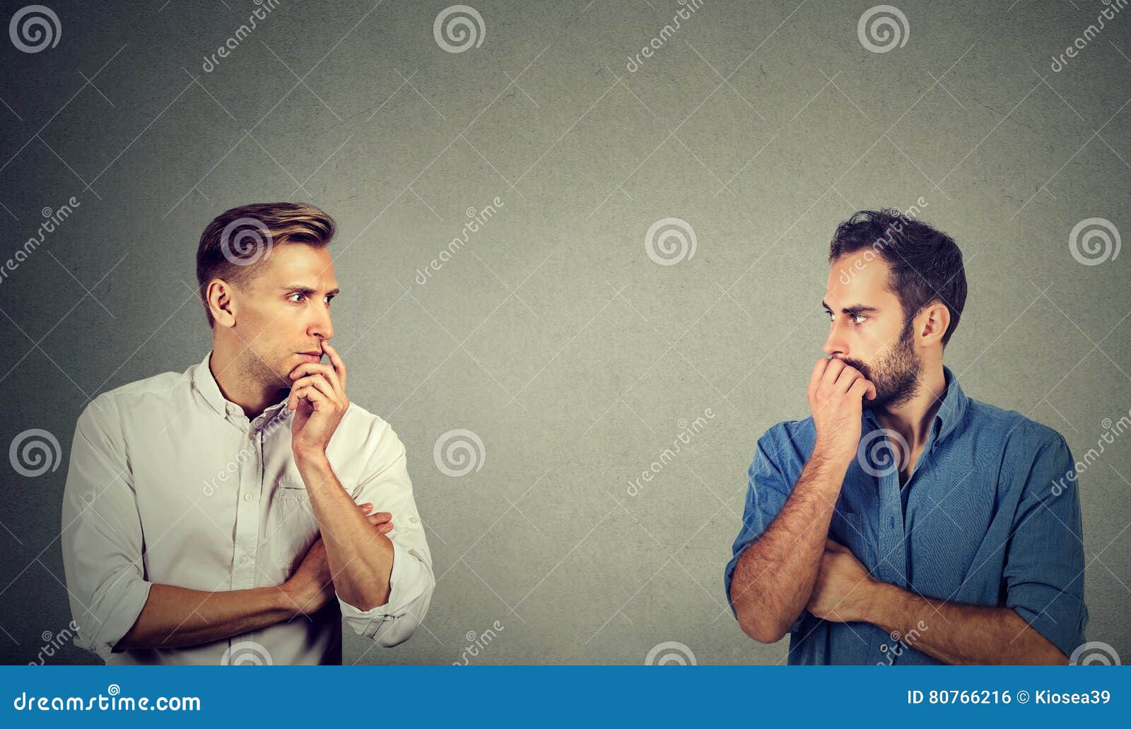 profile of two preoccupied businessmen looking at each other