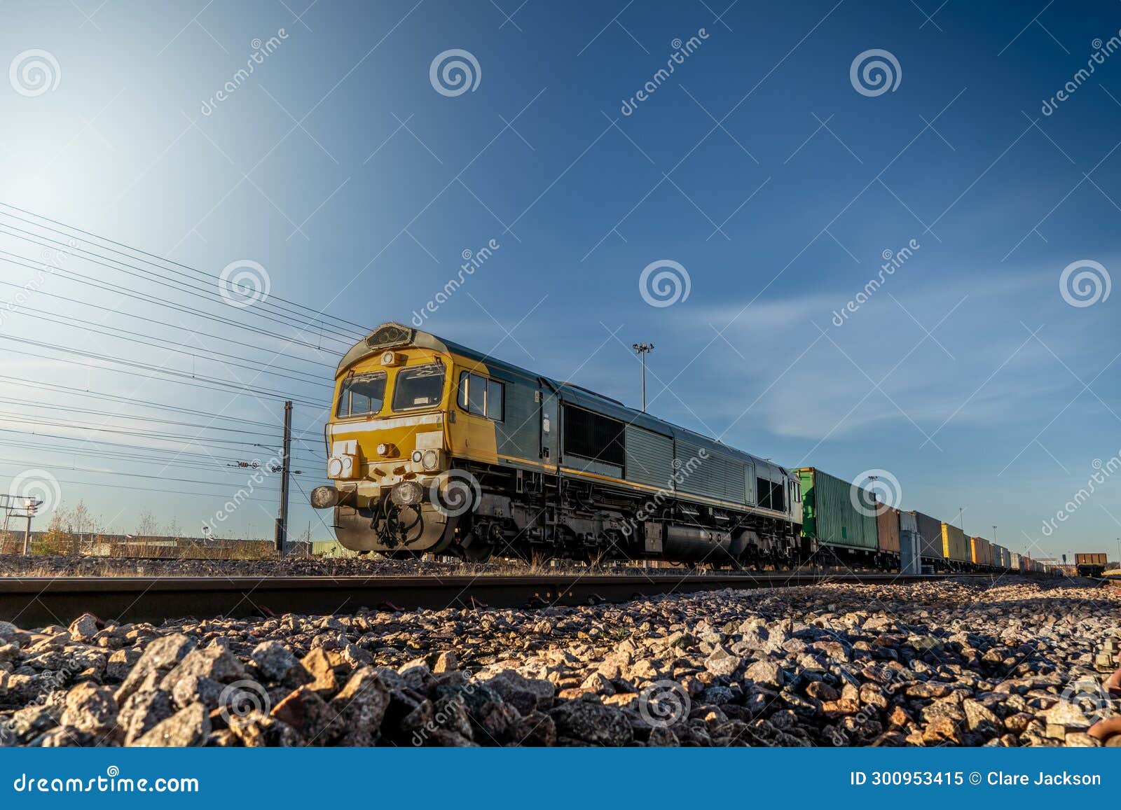 A UK Freight Train with and Wagons Transporting Shipping