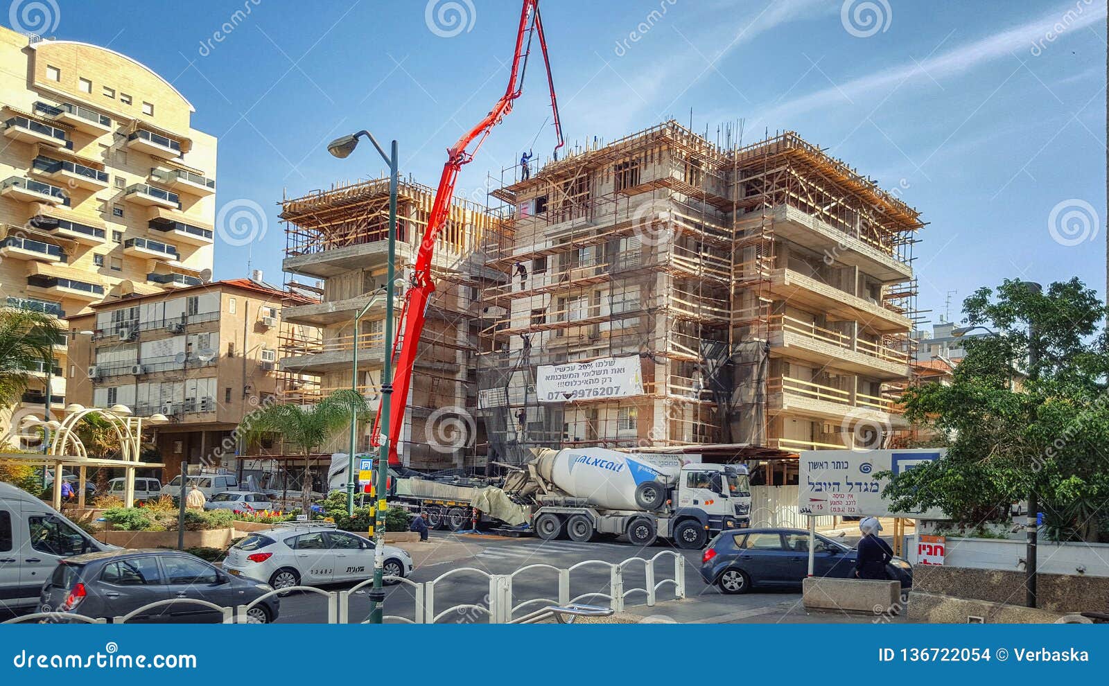 Scaffolding surrounds the old 4-floor residential building for reinforcement the structure and building up additional stories.